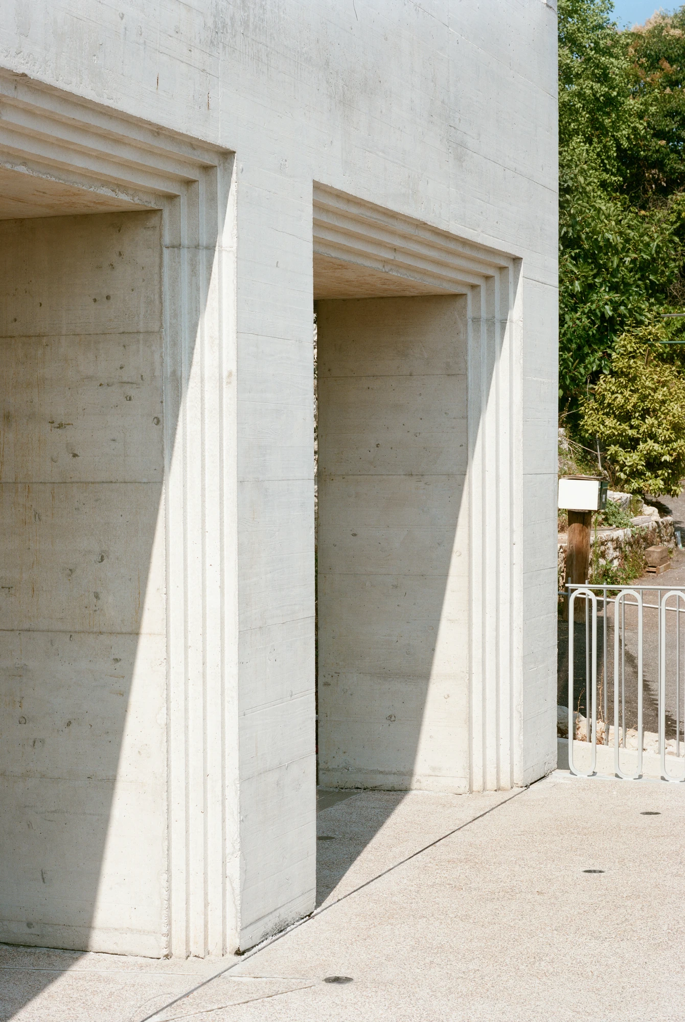 Biot Municipal Building Extension by Atelier EGR, photographed by Giaime Meloni — Close view of two openings, showing the stepped reveals and the horizontal marks left by the timber shuttering.