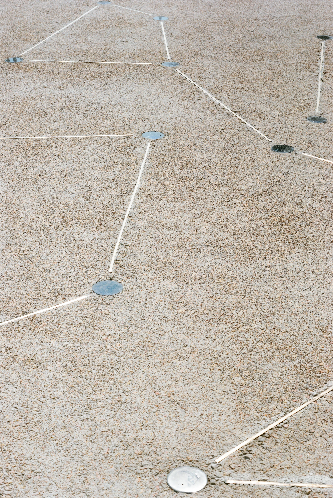 Biot Municipal Building Extension by Atelier EGR, photographed by Giaime Meloni — Detail of the deck paving, exposed aggregate inlaid with slim metal lines running between polished discs.