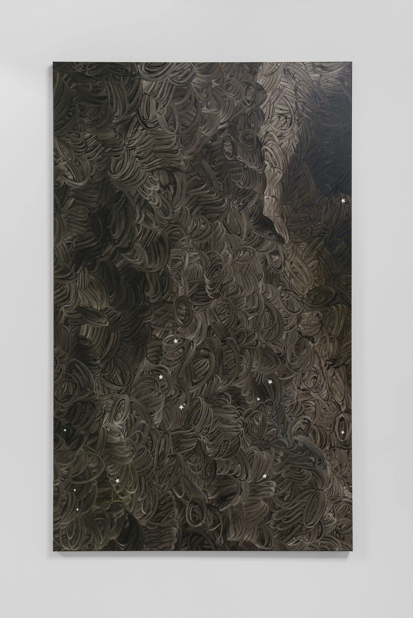 Apophenia by Galerie Molitor, photographed by Marjorie Brunet-Plaza — A tall painting of dense looping grey and brown ribbons, small white stars scattered through the tangle.