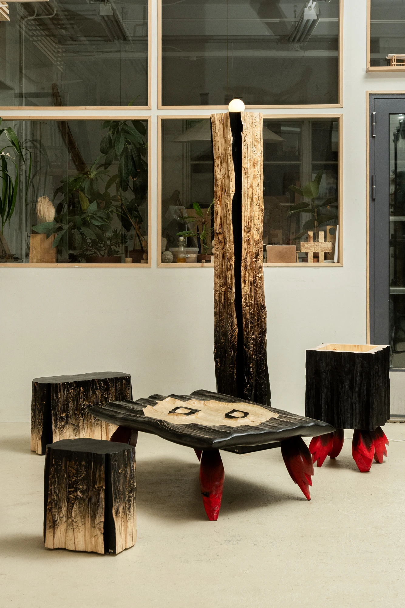 In Between Wood and Fire by Didi NG Wing Yin, photographed by Didi NG Wing Yin — The In Between Wood and Fire collection assembled in the studio, the Pith Floor Lamp lit behind the Rocket Side Coffee Table with the two Pith stools and Rocket Side Table…