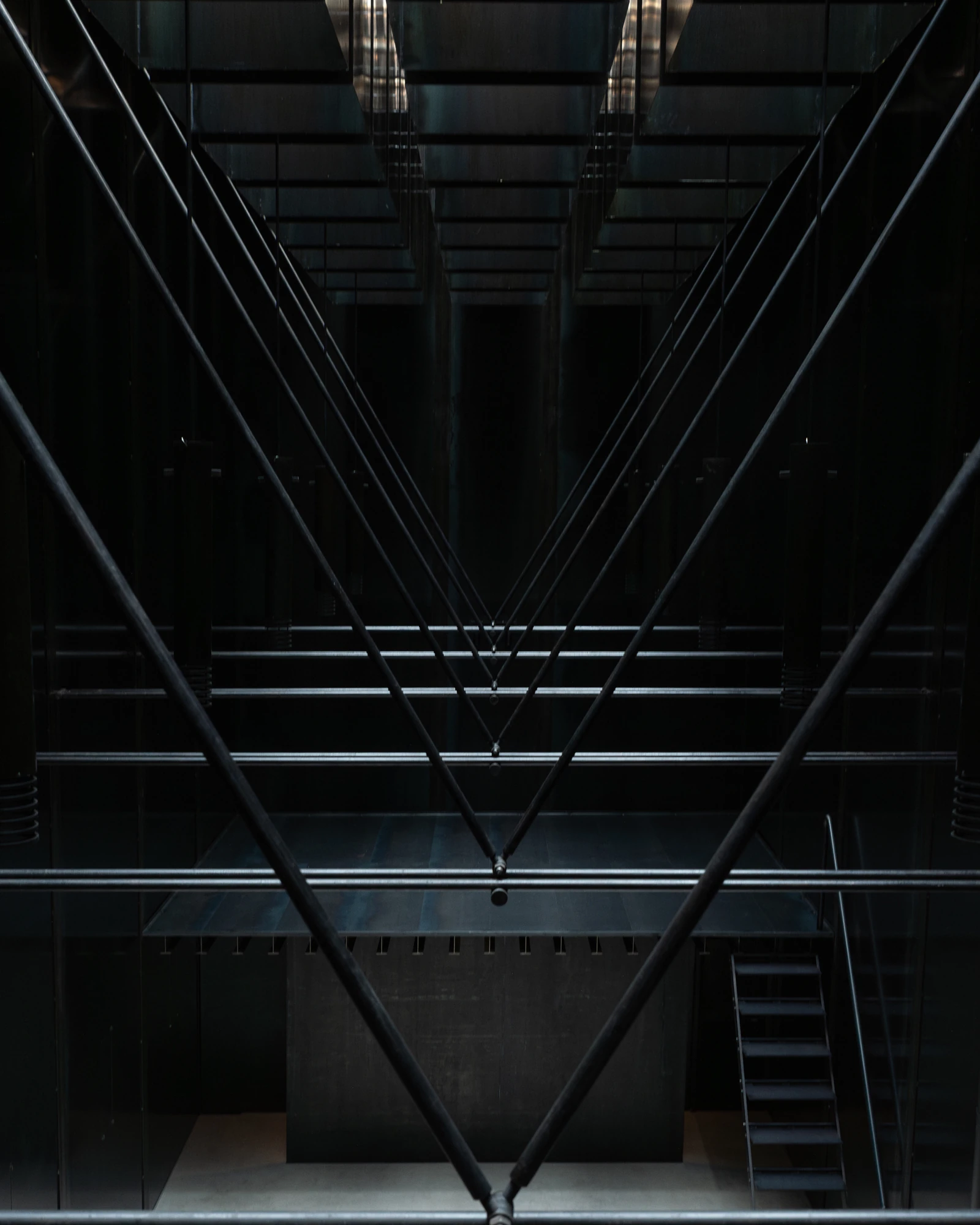 Shironishi Office by Tomoaki Uno Architects, photographed by Nathanael Bennett — The V of the bracing rods against the underside of the mezzanine, every member in black steel.