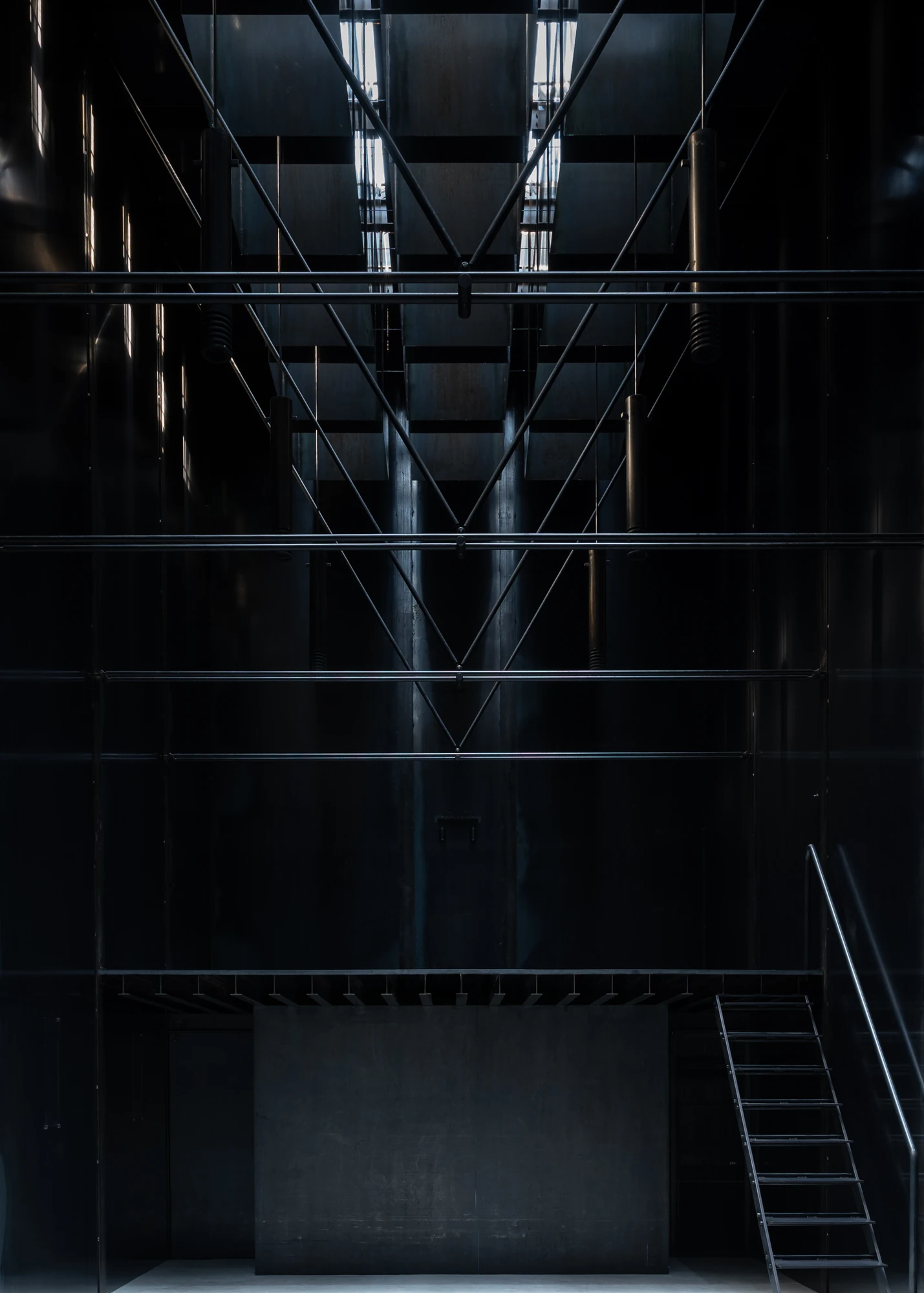 Shironishi Office by Tomoaki Uno Architects, photographed by Nathanael Bennett — Looking up into the grid of shafts, rods meeting in shallow V's beneath the white slots of the skylights.