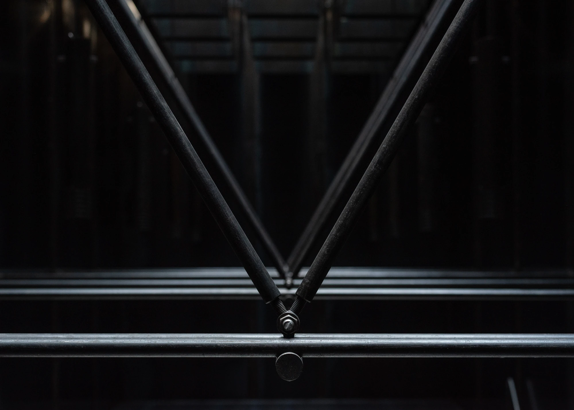 Shironishi Office by Tomoaki Uno Architects, photographed by Nathanael Bennett — Close on the junction where two threaded rods are drawn down to a single bolt over a horizontal tie.