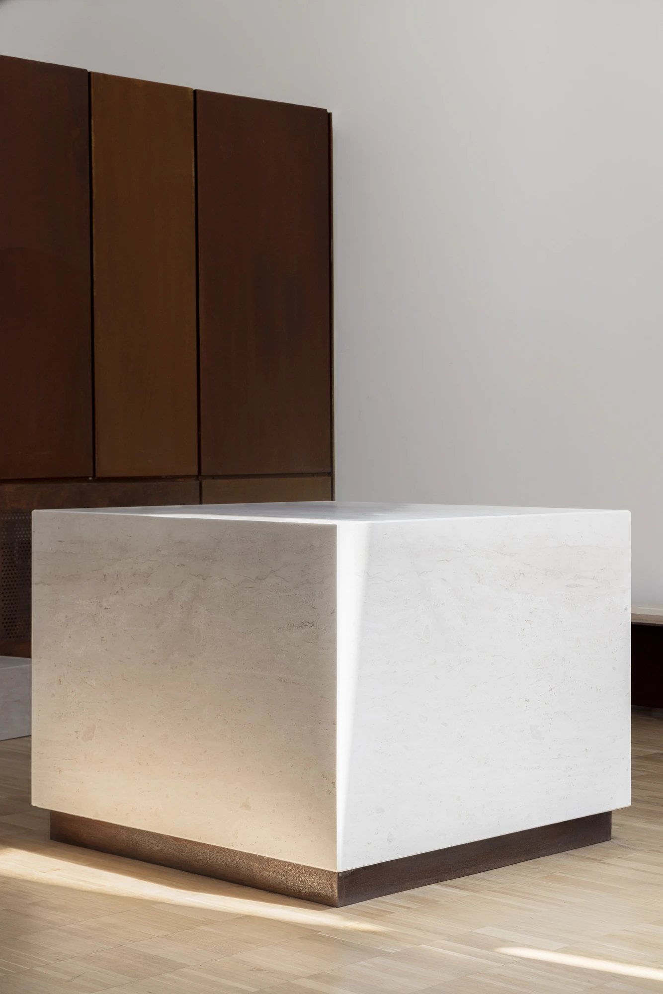 Complesso parrocchiale e Chiesa della Beata Vergine Assunta by Carlo Atzeni, Silvia Mocci, Maurizio Manias, Franceschino Serra, photographed by Studio Vetroblu — A monolith of white Orosei marble rests on a corten steel base, its top face catching the…