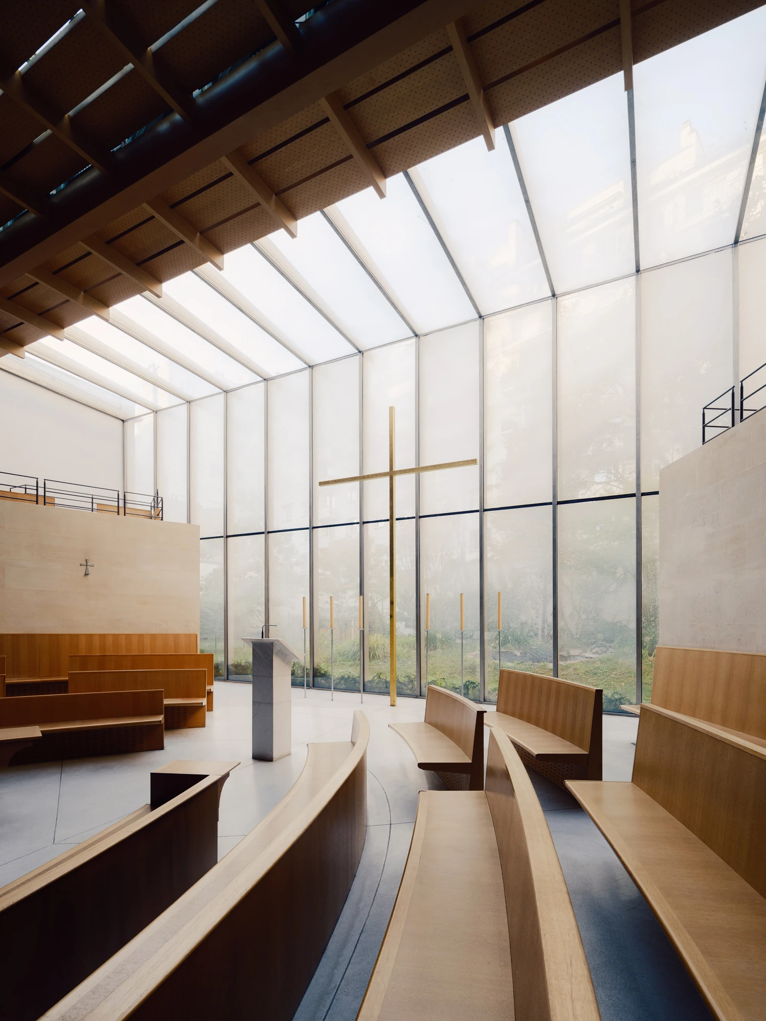 Église Saint-François de Molitor by Corinne Callies and Jean-Marie Duthilleul — The glazed screen rises and folds into a sloped roof of timber beams, filling the nave with diffused white light.
