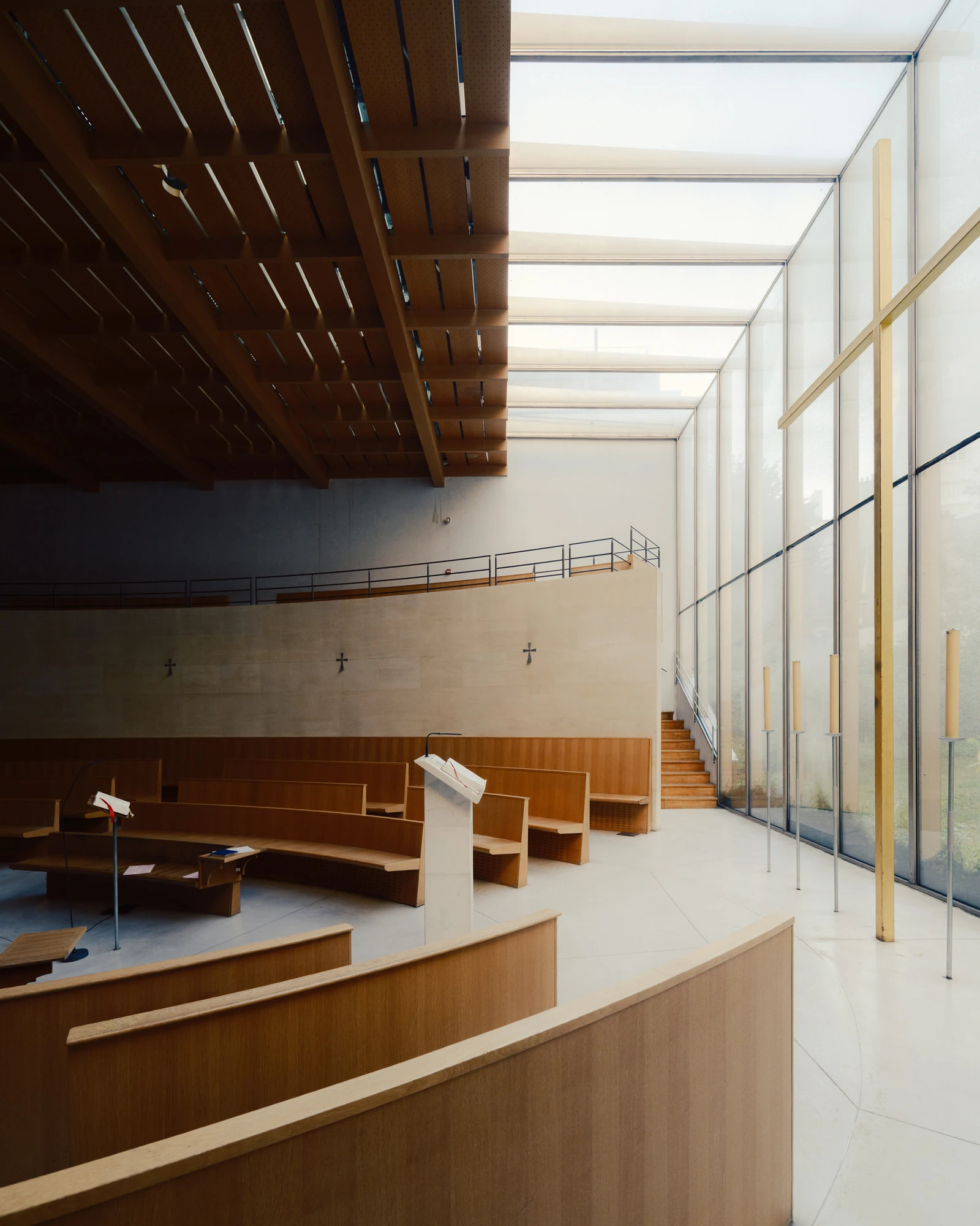 Église Saint-François de Molitor by Corinne Callies and Jean-Marie Duthilleul — The ambulatory running between the outer glazed wall and the curved back of the benches, its stone floor catching the light.