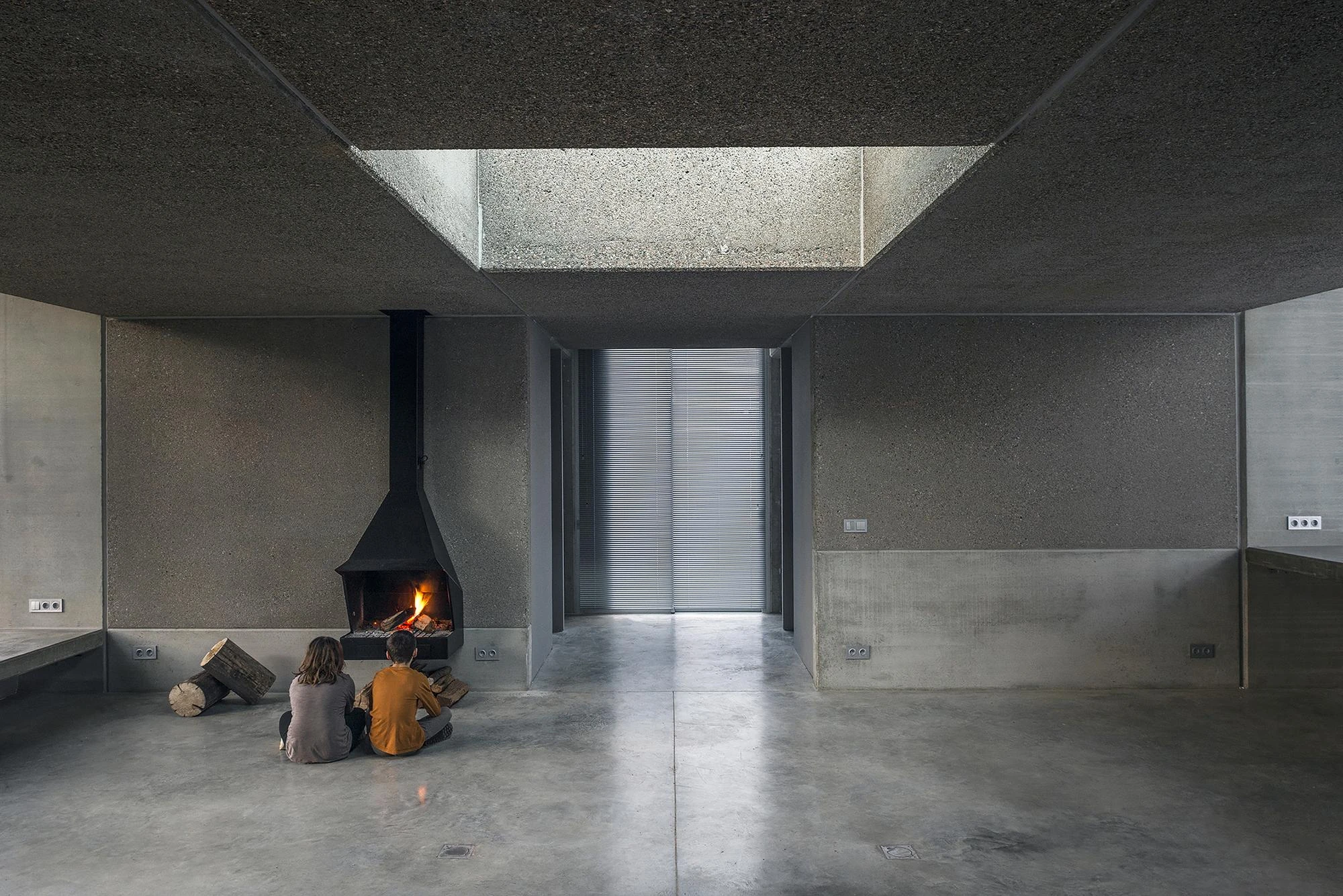 Prefab Pavilion Facing a Centuries-Old Cedar by Jordi Hidalgo Tané, photographed by Pep Sau, Jordi Hidalgo — Interior view of the pavilion's living space beside the fireplace.