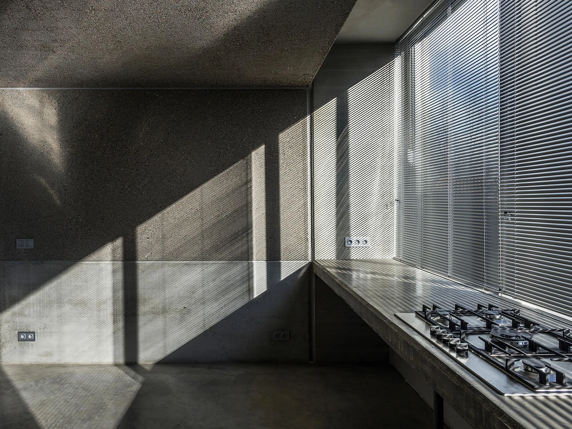 Prefab Pavilion Facing a Centuries-Old Cedar by Jordi Hidalgo Tané, photographed by Pep Sau, Jordi Hidalgo — Interior view of the concrete kitchen counter along the glazed side of the pavilion.