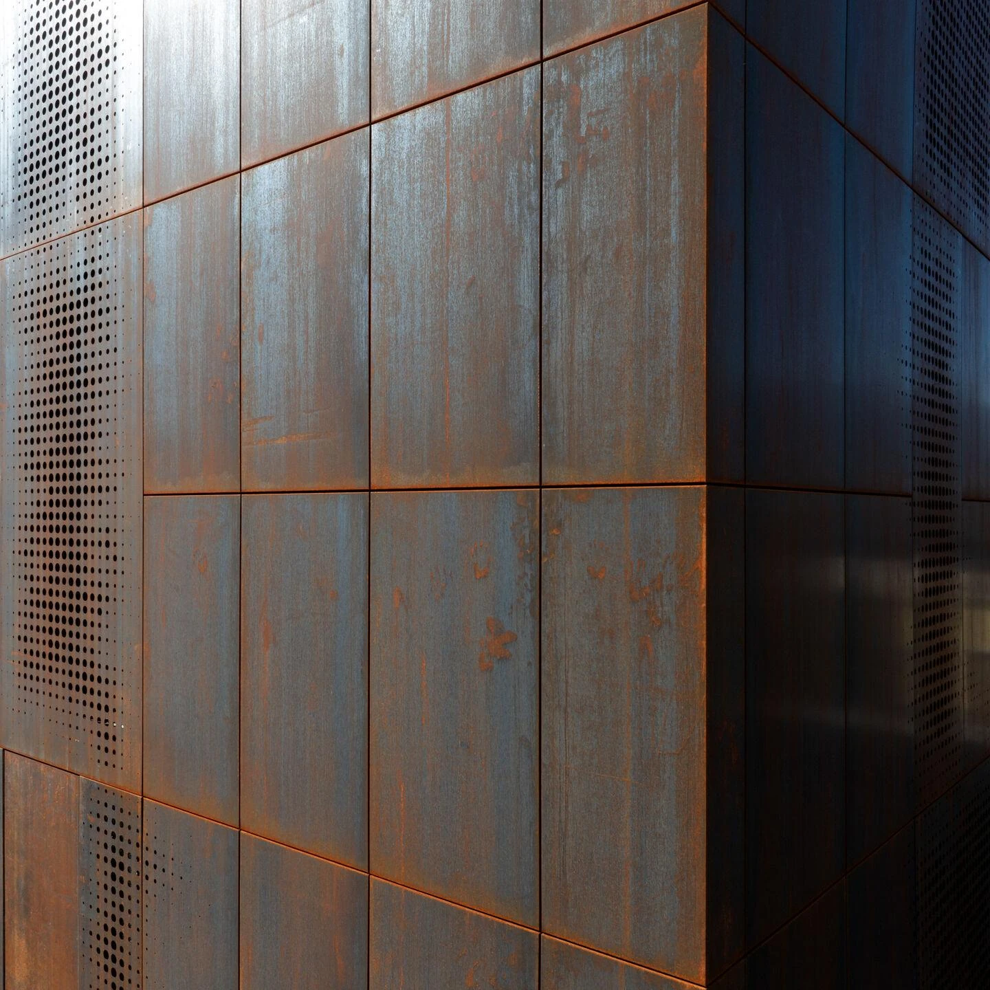 Urs Hauser Winery by WDMRA, photographed by Giacomo Albo — A tight corner detail, raking light crossing the weathered Corten panels and their fine horizontal seams.