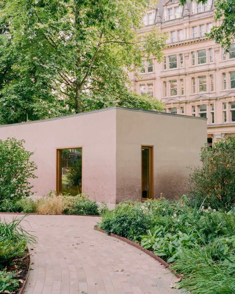 Finsbury Circus Parks Office by Studio Weave, photographed by Lorenzo Zandri — Two tall windows set into the clay-render walls open the working base onto the planted garden and the stone frontages beyond.