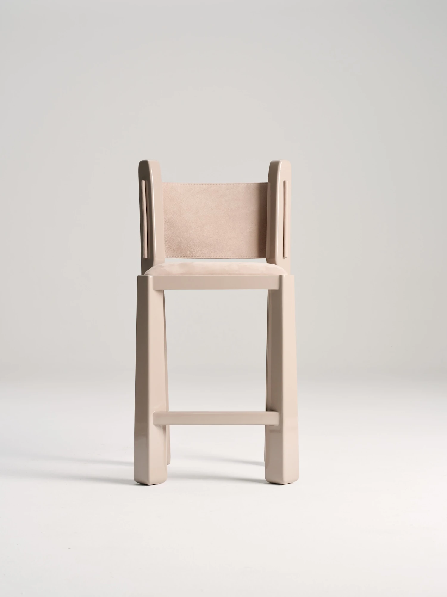 Ruby by NOVSEP, photographed by NOVSEP — Three-quarter view of the greige Ruby chair on a seamless white ground, suede seat and back set into the high-gloss frame.