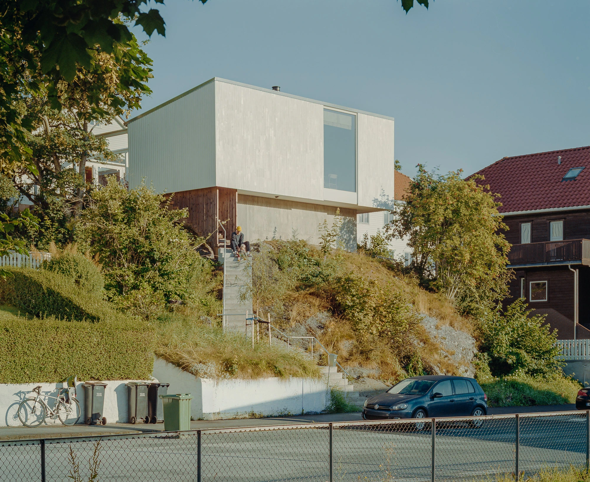 Ersland & Skeie House by Knut Hjeltnes Architects, photographed by Hugo Lütcherath — A stair meanders up the bedrock to a hanging stair that leads into the hovering house.