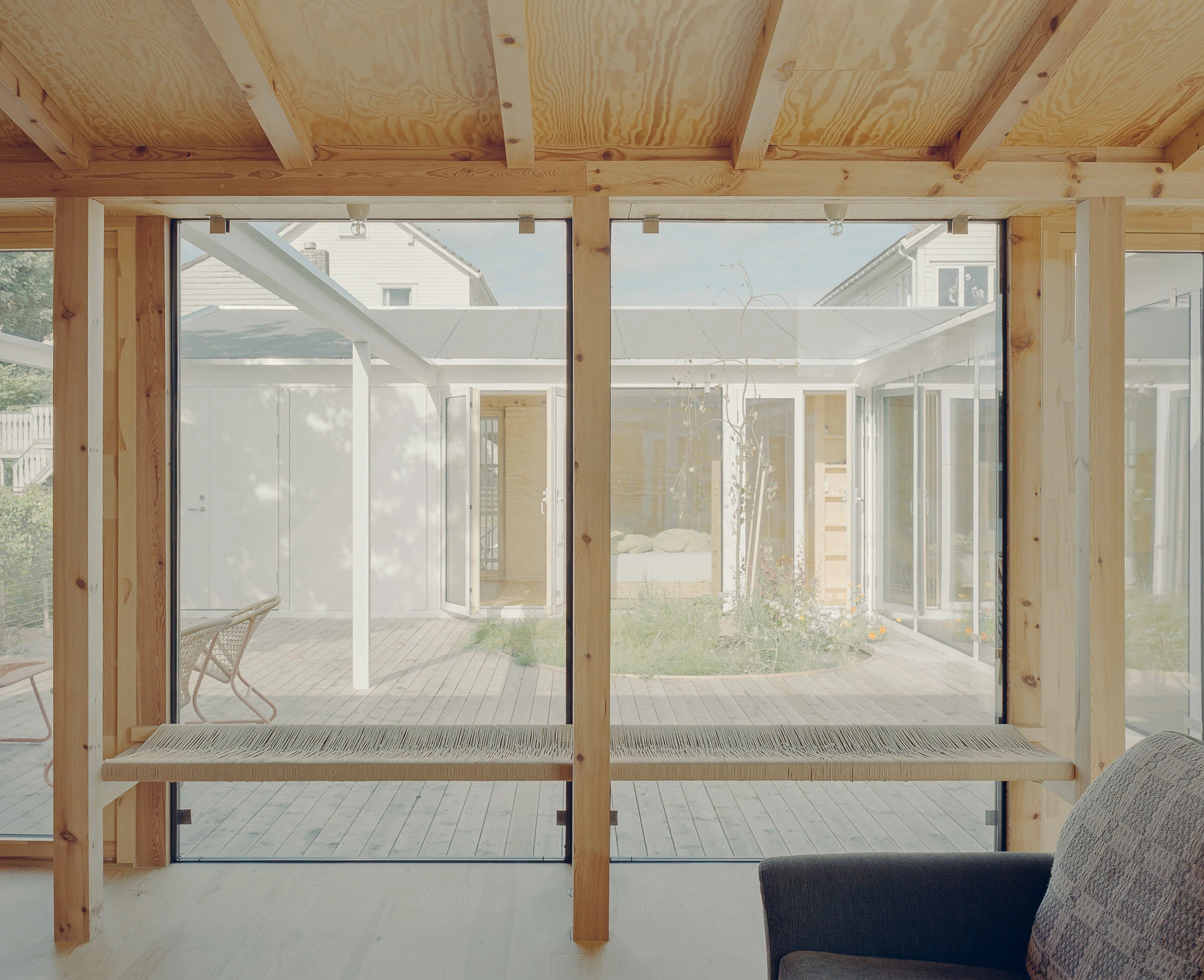 Ersland & Skeie House by Knut Hjeltnes Architects, photographed by Hugo Lütcherath — The bathroom is clad in brass, left to develop its patina over time, around a white tub.