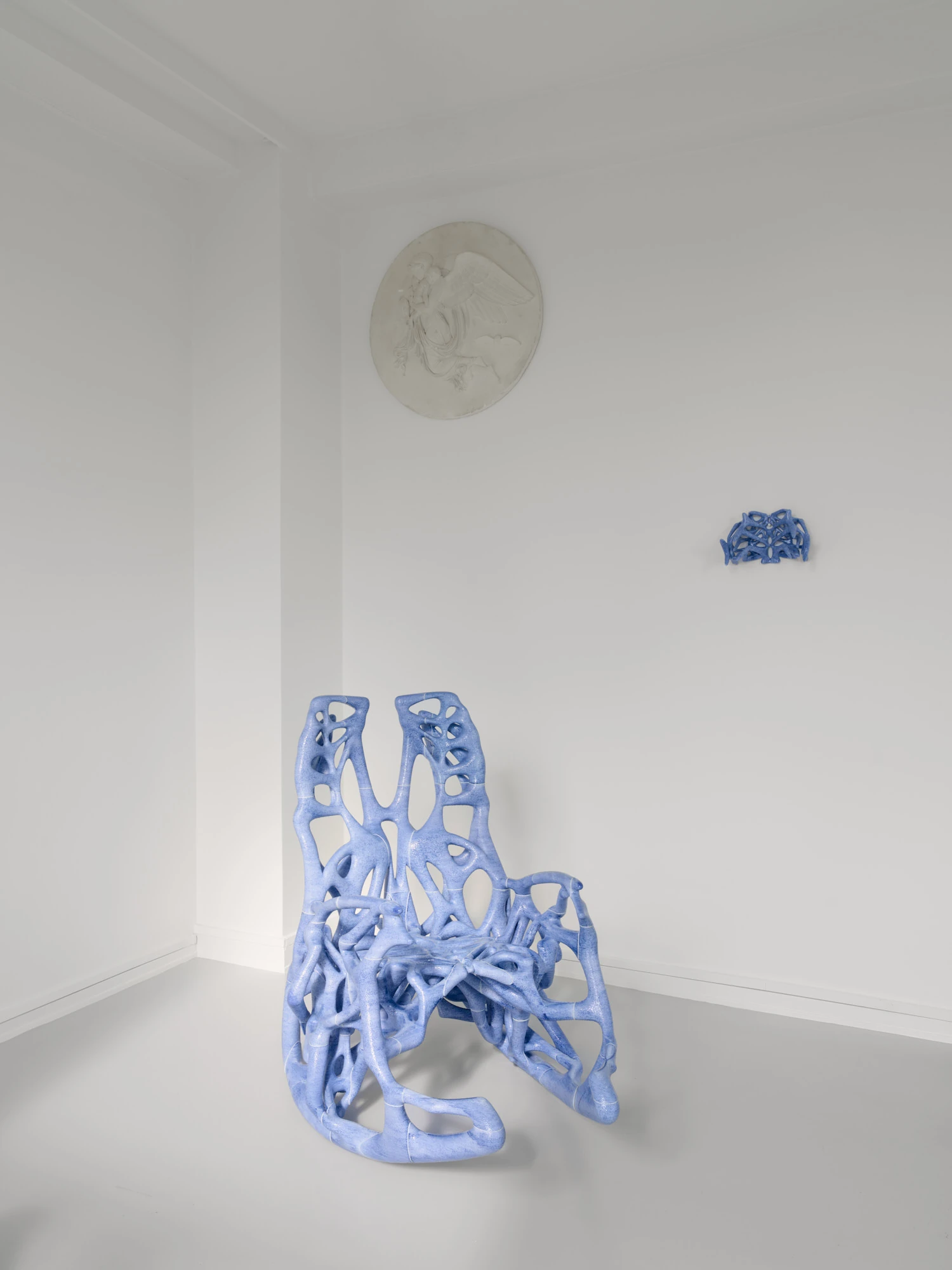 Extrude, Bridge, Fill by Lasse Sylvest Lilleør, photographed by Robert Damisch — Installation view of Extrude, Bridge, Fill, the bone-blue Rocking Chair at left and the black Dazing Devil lounger crossing the floor.