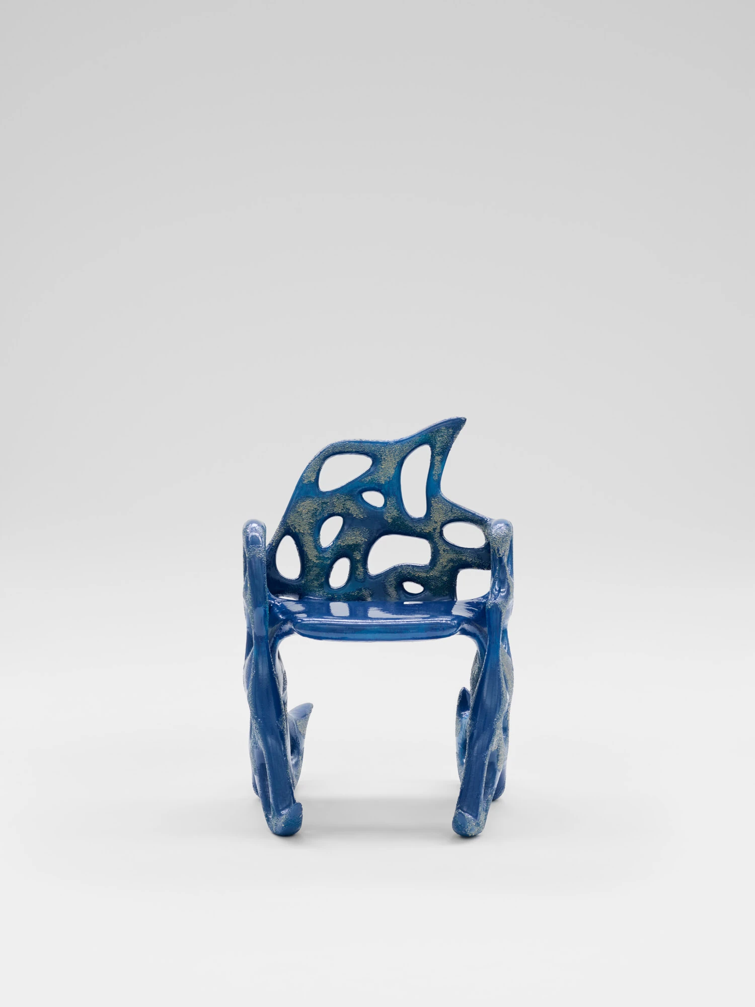 Extrude, Bridge, Fill by Lasse Sylvest Lilleør, photographed by Robert Damisch — Front view of the Sleigh Chair, the perforated back and seat glazed a deep cobalt.