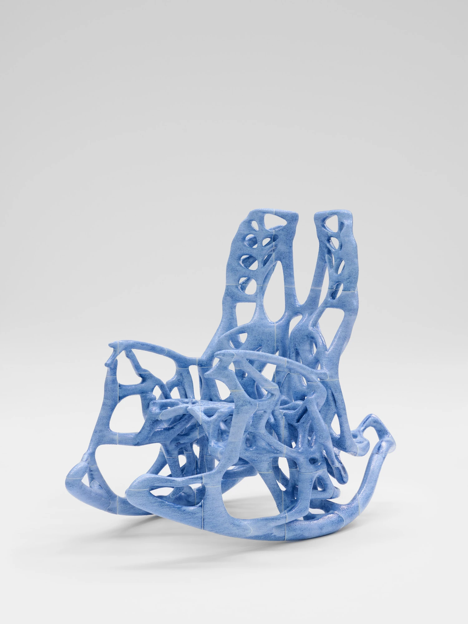 Extrude, Bridge, Fill by Lasse Sylvest Lilleør, photographed by Robert Damisch — Three-quarter view of the Rocking Chair in PLA, resin and dye, the tiled printed segments meeting across its frame.