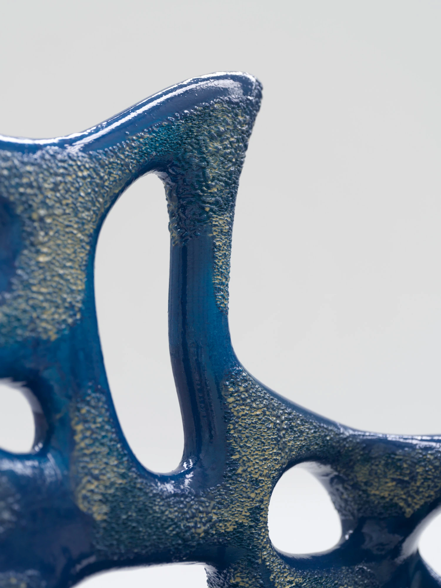 Extrude, Bridge, Fill by Lasse Sylvest Lilleør, photographed by Robert Damisch — Macro of the Sleigh Chair, the ribbed openings where gloss meets rough print texture.