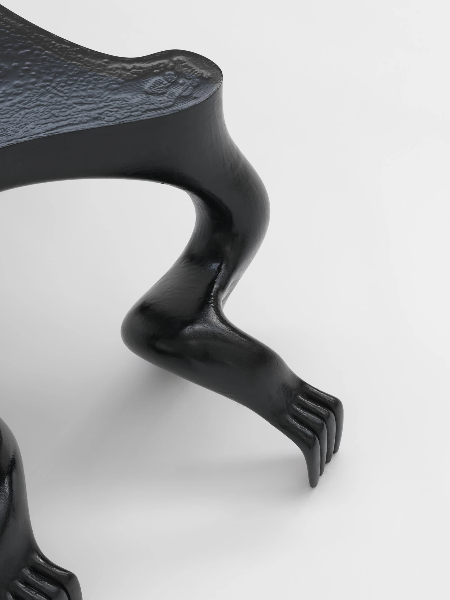 Extrude, Bridge, Fill by Lasse Sylvest Lilleør, photographed by Robert Damisch — Close view of a single leg of the Crawler Coffee Table, bent at the knee and ending in a clawed hand.