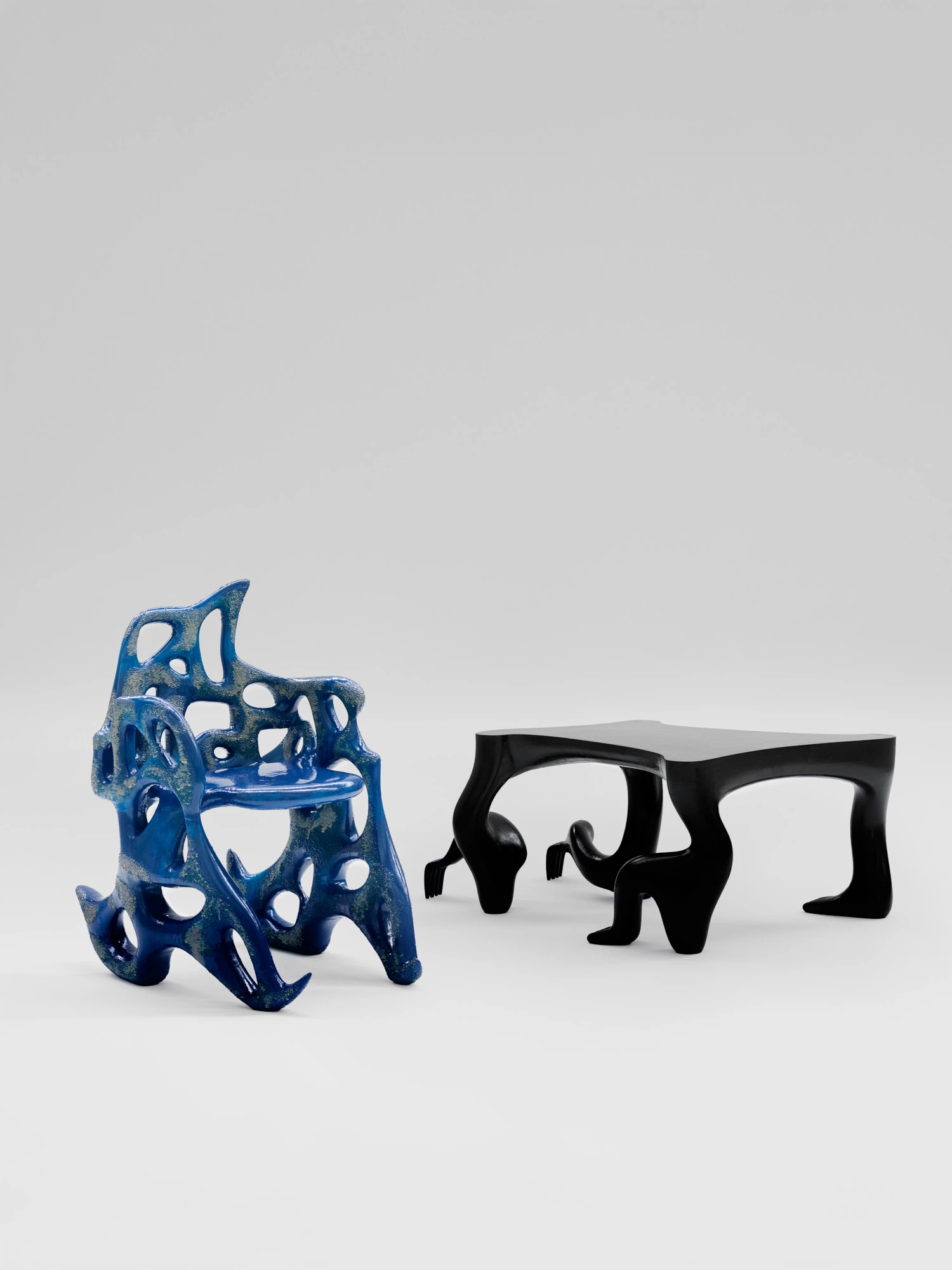Extrude, Bridge, Fill by Lasse Sylvest Lilleør, photographed by Robert Damisch — The Sleigh Chair and the Crawler Coffee Table paired, cobalt beside black.