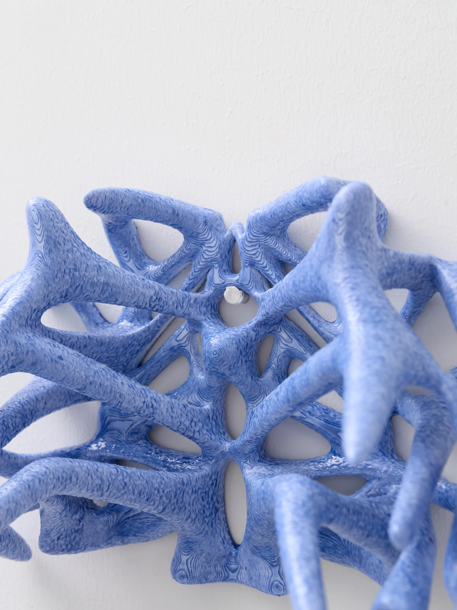 Extrude, Bridge, Fill by Lasse Sylvest Lilleør, photographed by Robert Damisch — Detail of the wall-mounted rib vase, its layered blue filaments and radiating pattern.