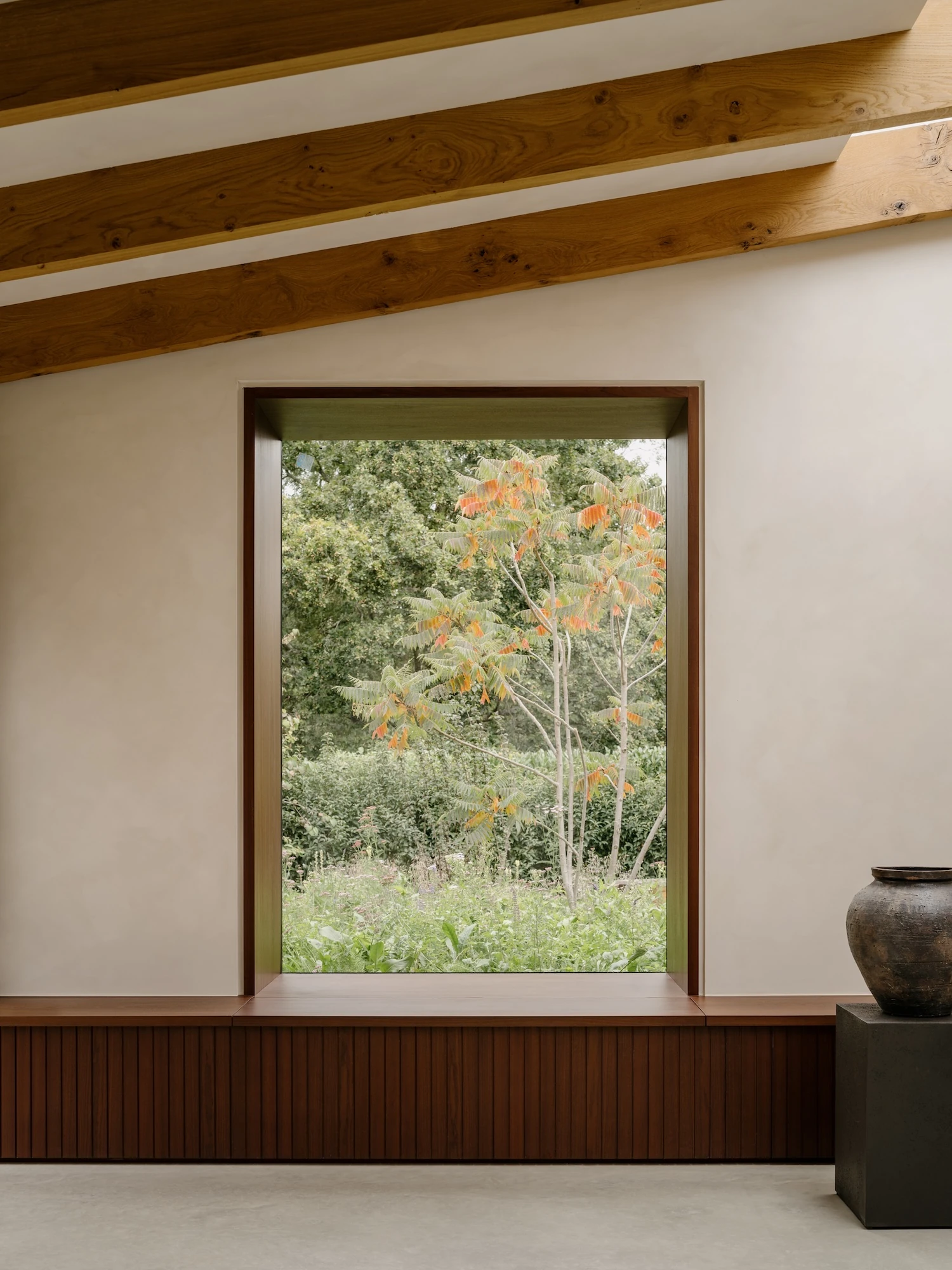 Muttram Veedu by Will Gamble Architects, photographed by James Retief — Bifolding doors fold back from the living room onto the courtyard, where water sits in a raised trough among the planting.