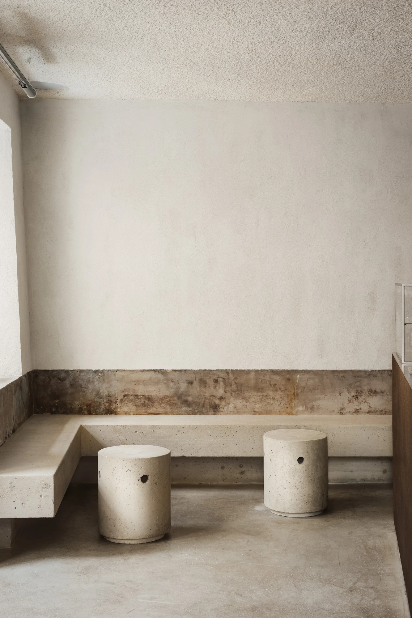 DAARK by Rodaa Studio, photographed by Adrien Ozouf — A built-in bench and seating inside DAARK by Rodaa Studio, Paris.