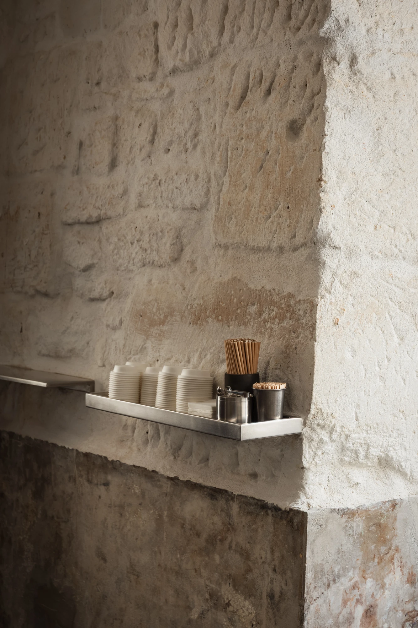 DAARK by Rodaa Studio, photographed by Adrien Ozouf — A window nook with seating and books inside DAARK by Rodaa Studio, Paris.
