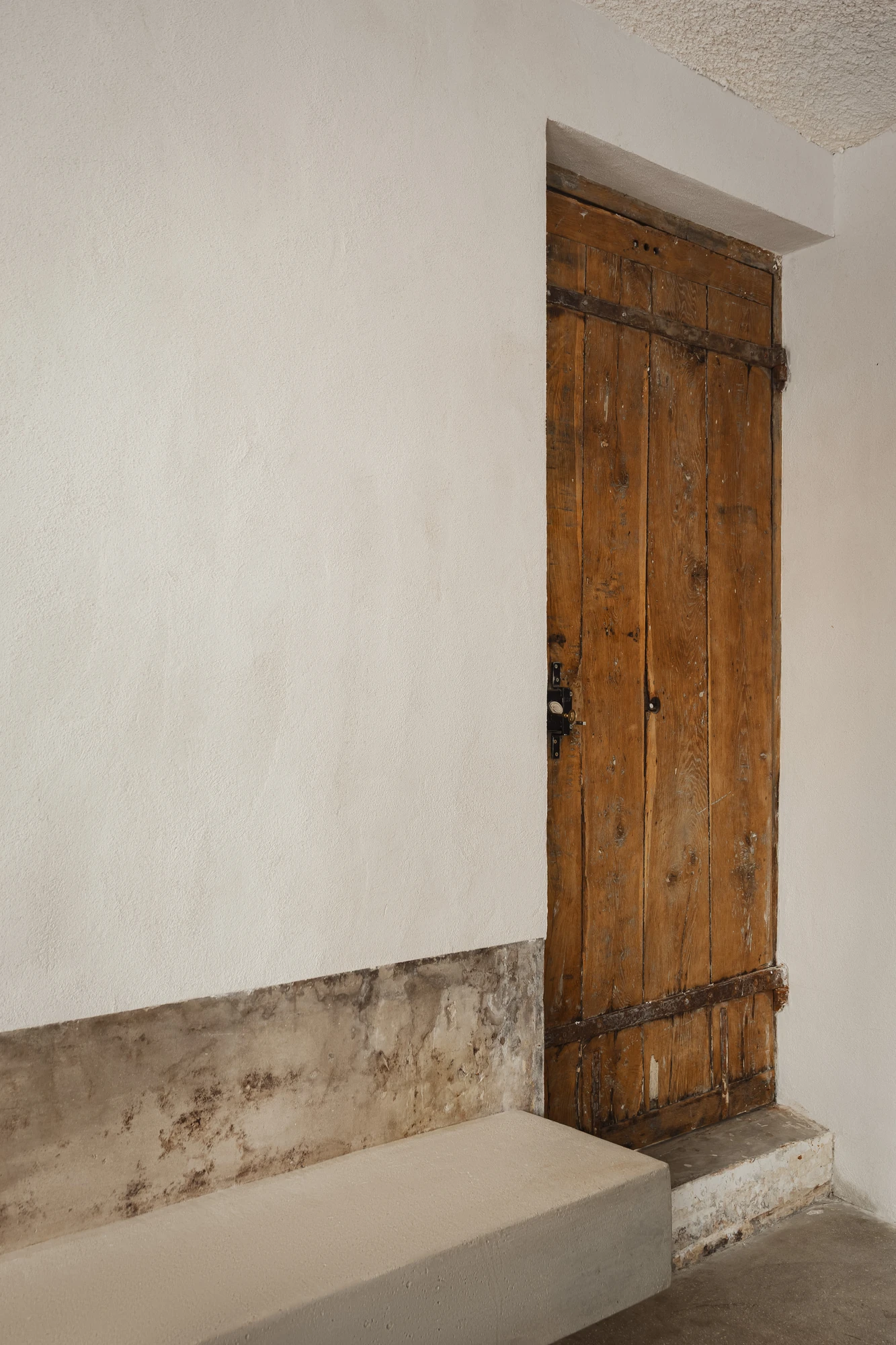 DAARK by Rodaa Studio, photographed by Adrien Ozouf — Interior seating beside an original doorway inside DAARK by Rodaa Studio, Paris.