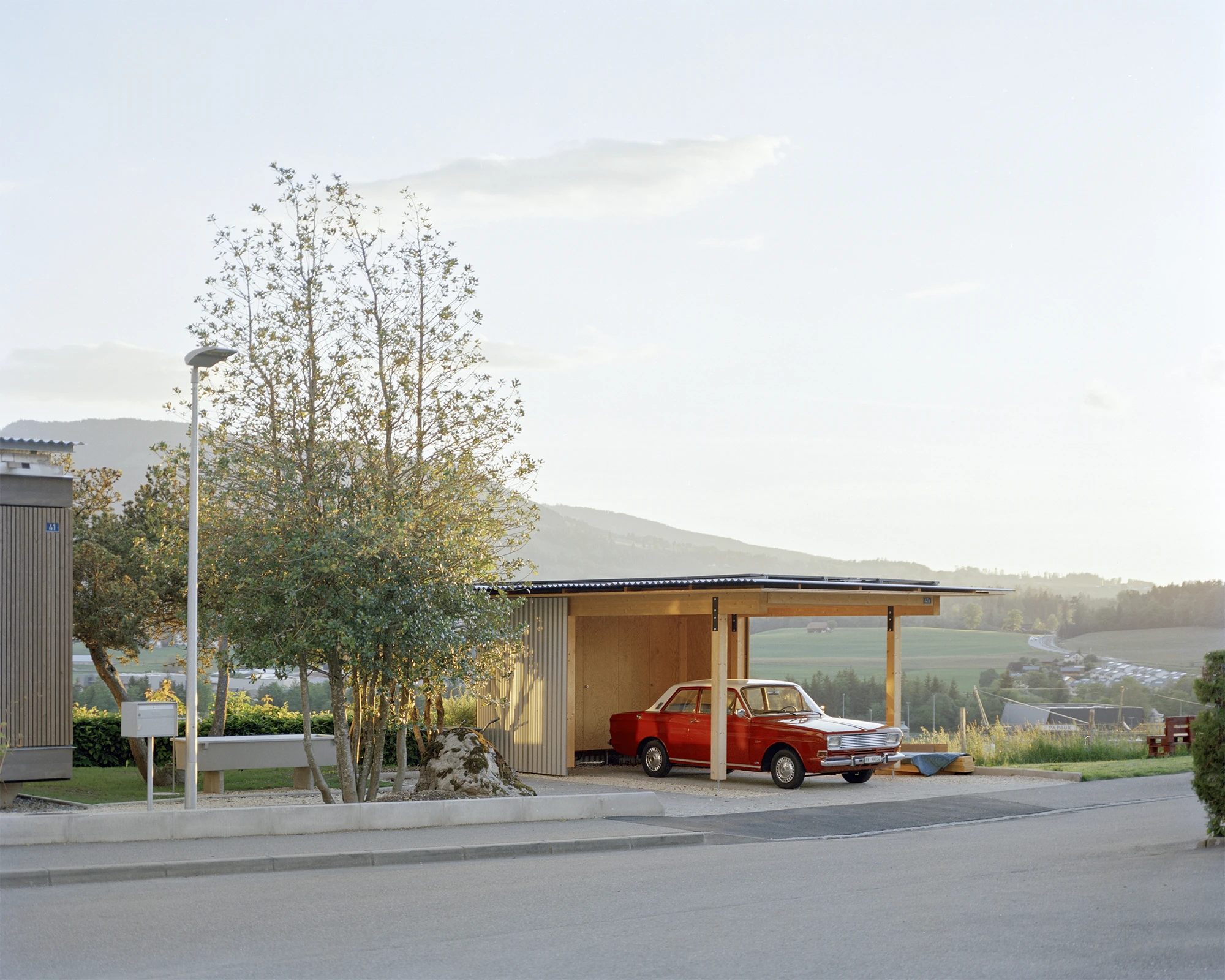 Plywood House by Charly Jolliet Architecte, photographed by Maxime Delvaux — A lightweight timber shelter marks the approach, built with the same constructive logic as the house.
