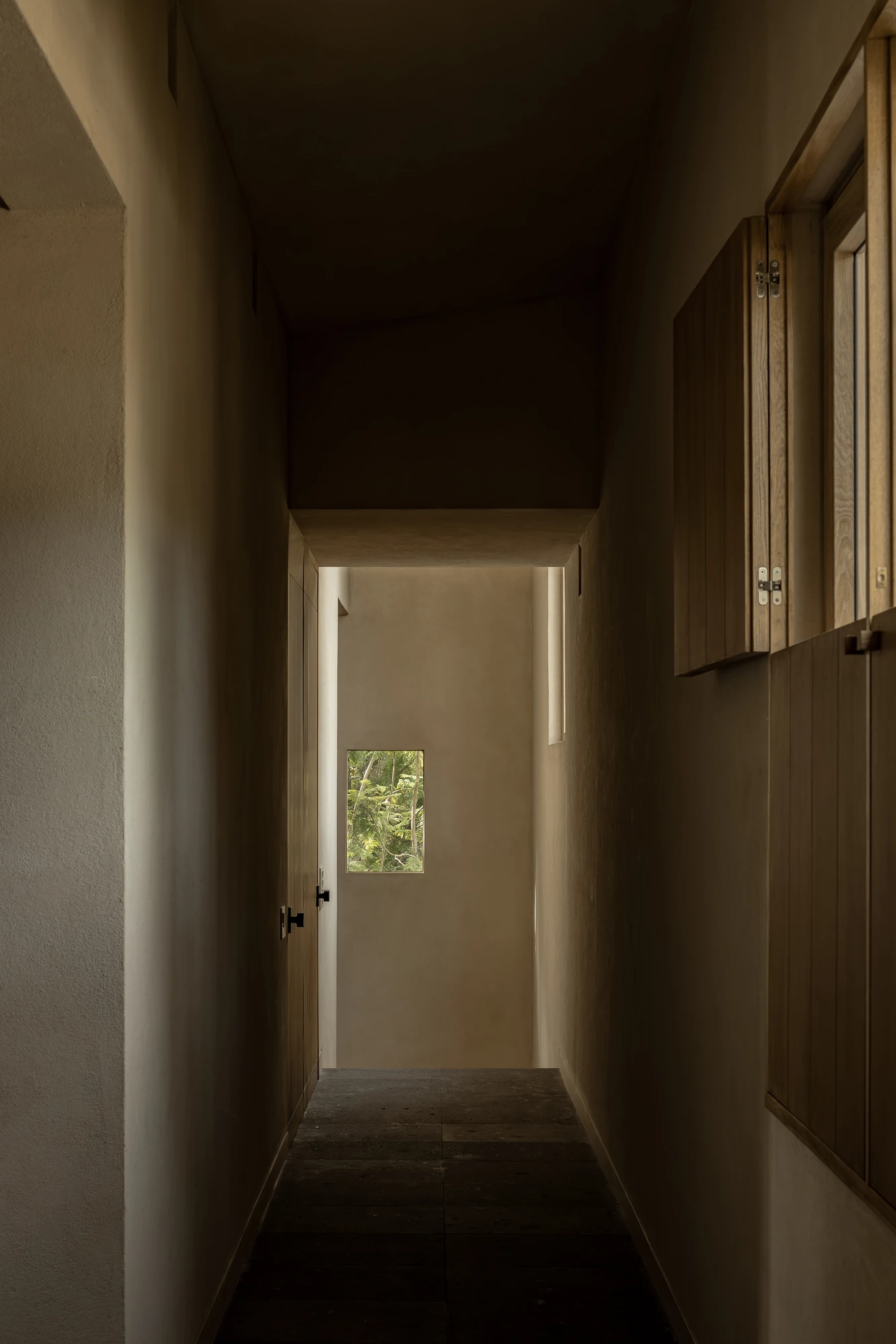PRM39 by Ana Victoria Pérez-Gil | Saúl Figueroa, photographed by Funciono — An interior passage lined with wood millwork frames a small window onto the forest.