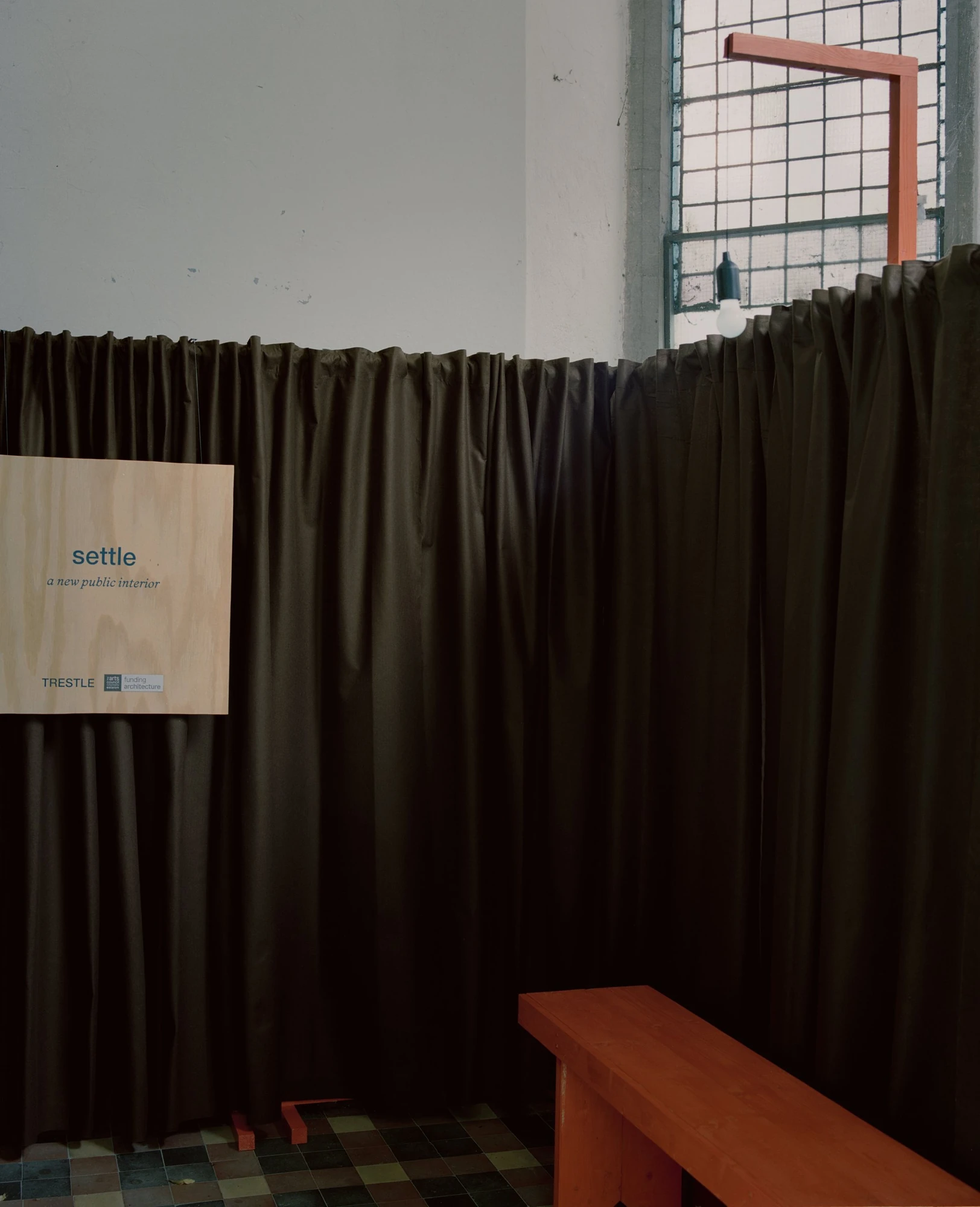 settle by Trestle, photographed by Willem Pab — settle, the temporary installation by Trestle, Cork City, 2026, its furniture pieces set out across a public interior.