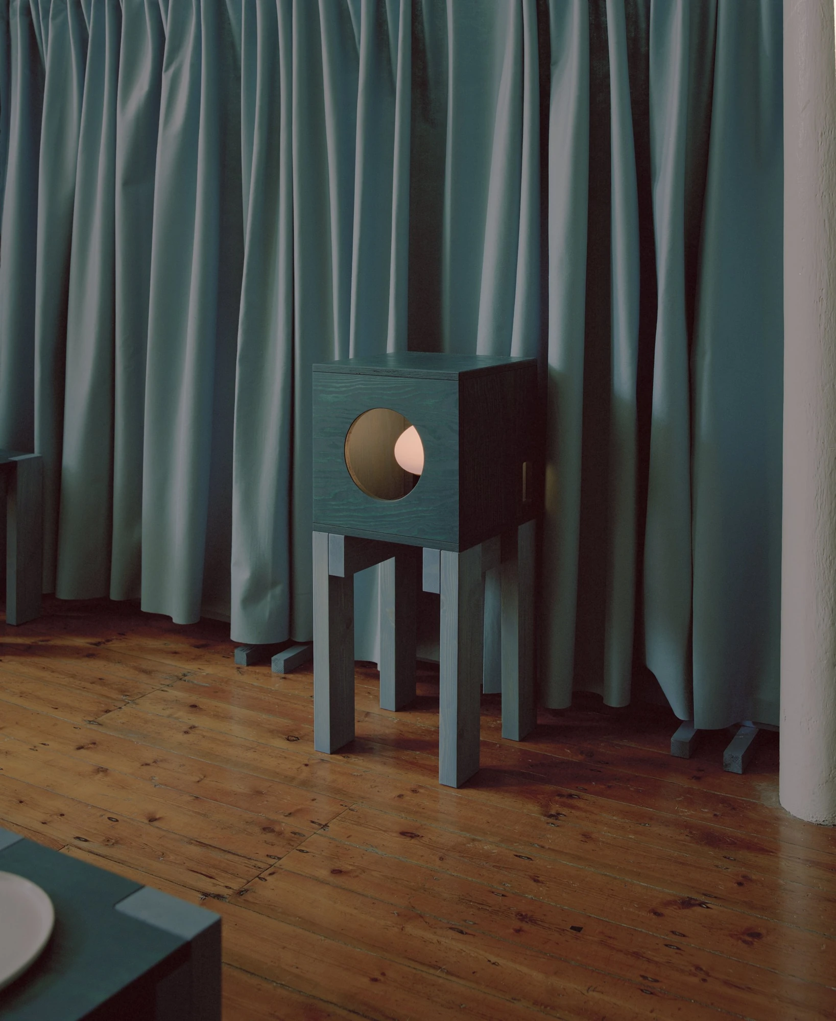 settle by Trestle, photographed by Willem Pab — settle by Trestle, Cork City, 2026, a lantern-form cabinet standing beside a hung curtain.