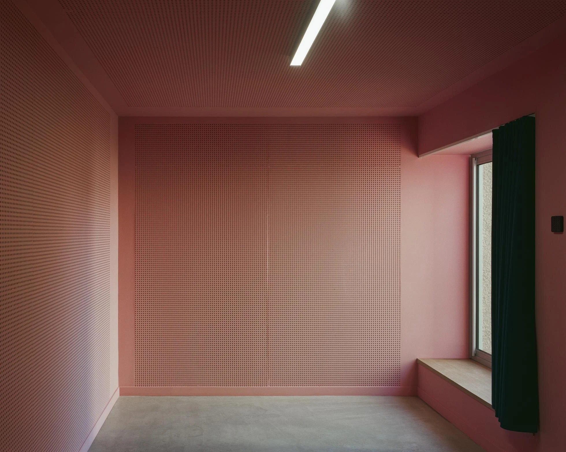 Cultural and Community Center, Coudoux by atelier EGR, photographed by Giaime Meloni — A music room is lined with perforated acoustic panelling, a seat set below the window.