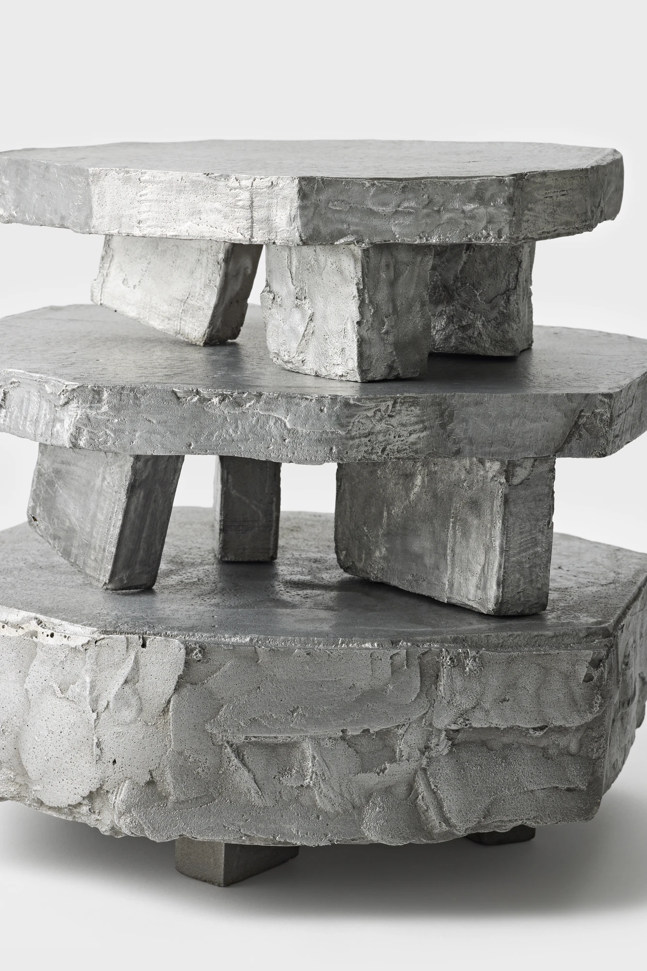 Lying on the floor by StudioFA, photographed by Yongin Myoung — The three pieces stacked one on top of another, the legs of each resting on the slab below it.