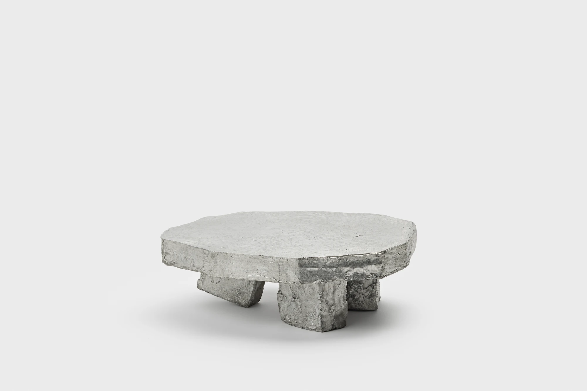 Lying on the floor by StudioFA, photographed by Yongin Myoung — A single piece on a plain ground, its top carried on three short blocks.