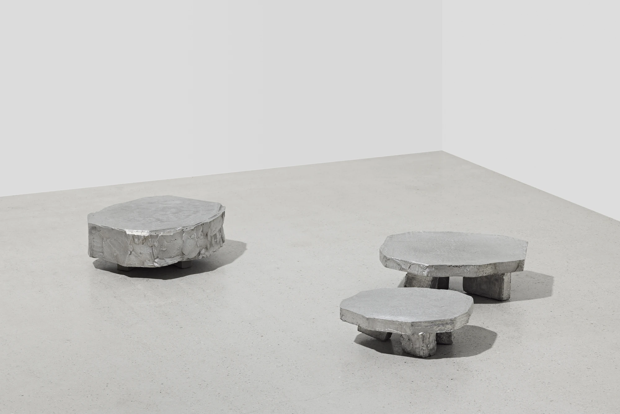 Lying on the floor by StudioFA, photographed by Yongin Myoung — The group in the corner of a white room, one piece sitting almost flush with the floor and two raised on legs.