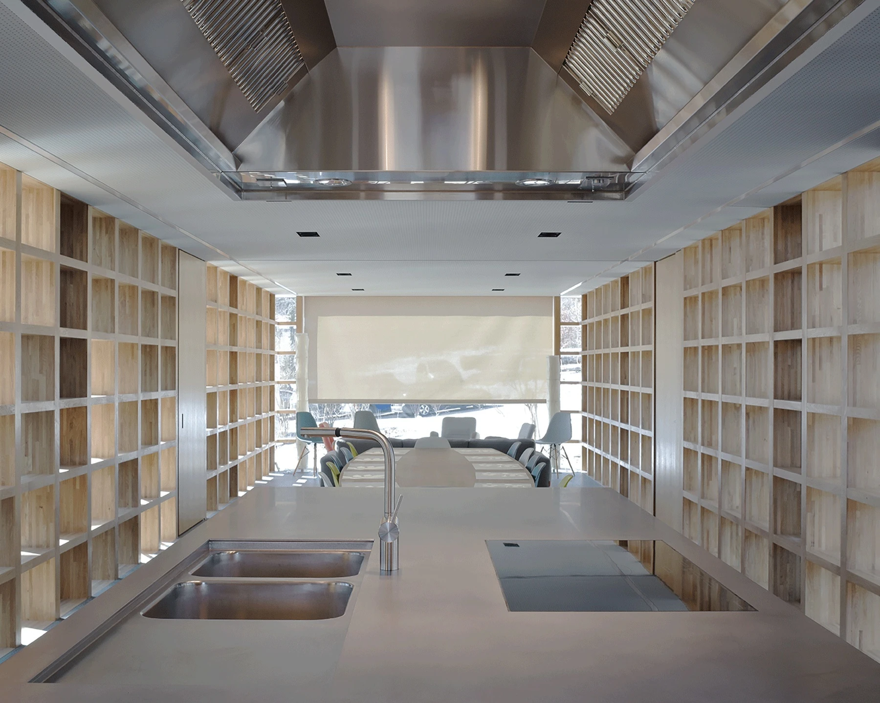 Writers' Cabins at the Jan Michalski Foundation by Kengo Kuma, ELEMENTAL, MK27 and Others, photographed by Leo Fabrizio, Tonatiuh Ambrosetti — The communal kitchen of ELEMENTAL's cabin centres on a stainless-steel island with a double sink and hob under…