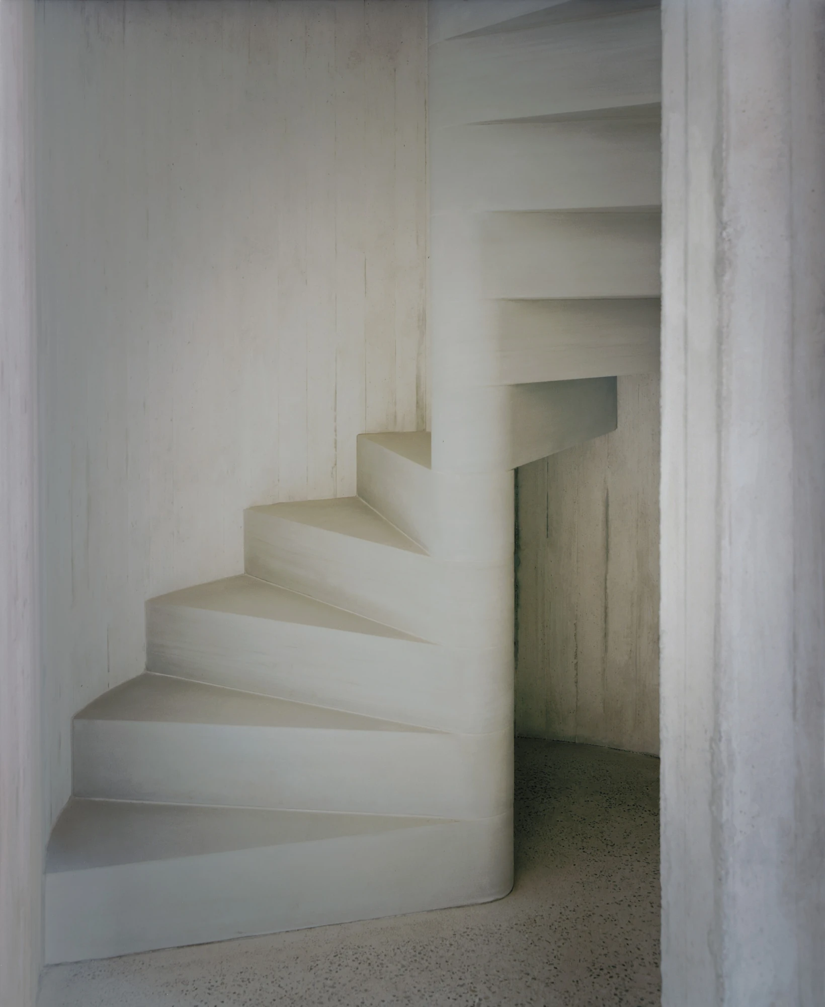 Conversion of a Farmhouse into Six Apartments by Noue Studio, photographed by Willem Pab — The pale sculptural stair winding up inside a narrow shaft.