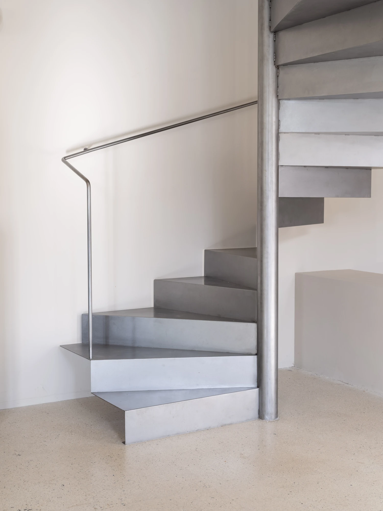 Farmhouse Renovation by Atelier AJO, photographed by Sandrine Iratçabal — A stair turning tightly around a central column.