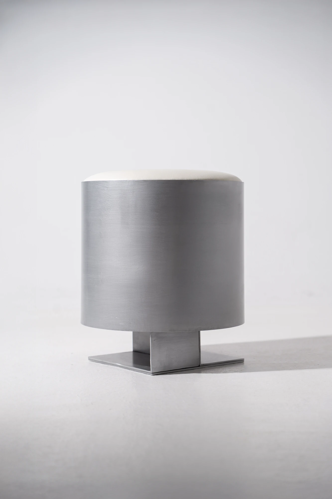 Strut Collection by YET. Design Studio, photographed by Kaan Bayoglu — The Strut Pouf shown alone, a rounded body with a circular seat rising from a square base.