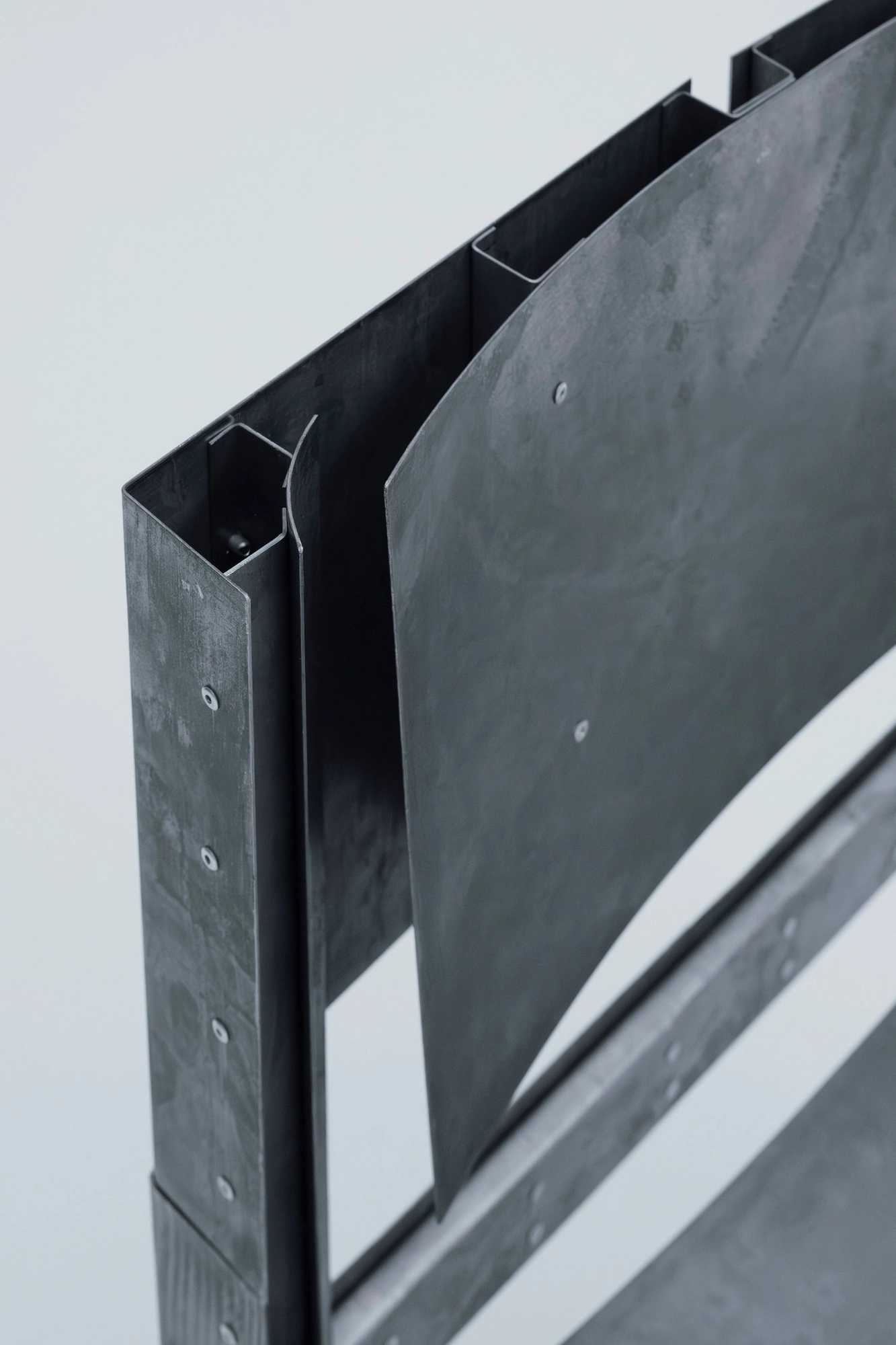 Trauer Tragen, Carrying Grief by Antonia Fischer, photographed by Maya Matsuura, Antonia Fischer — A close angled view of the upper back, the etched steel plates and their rivets seen up close.