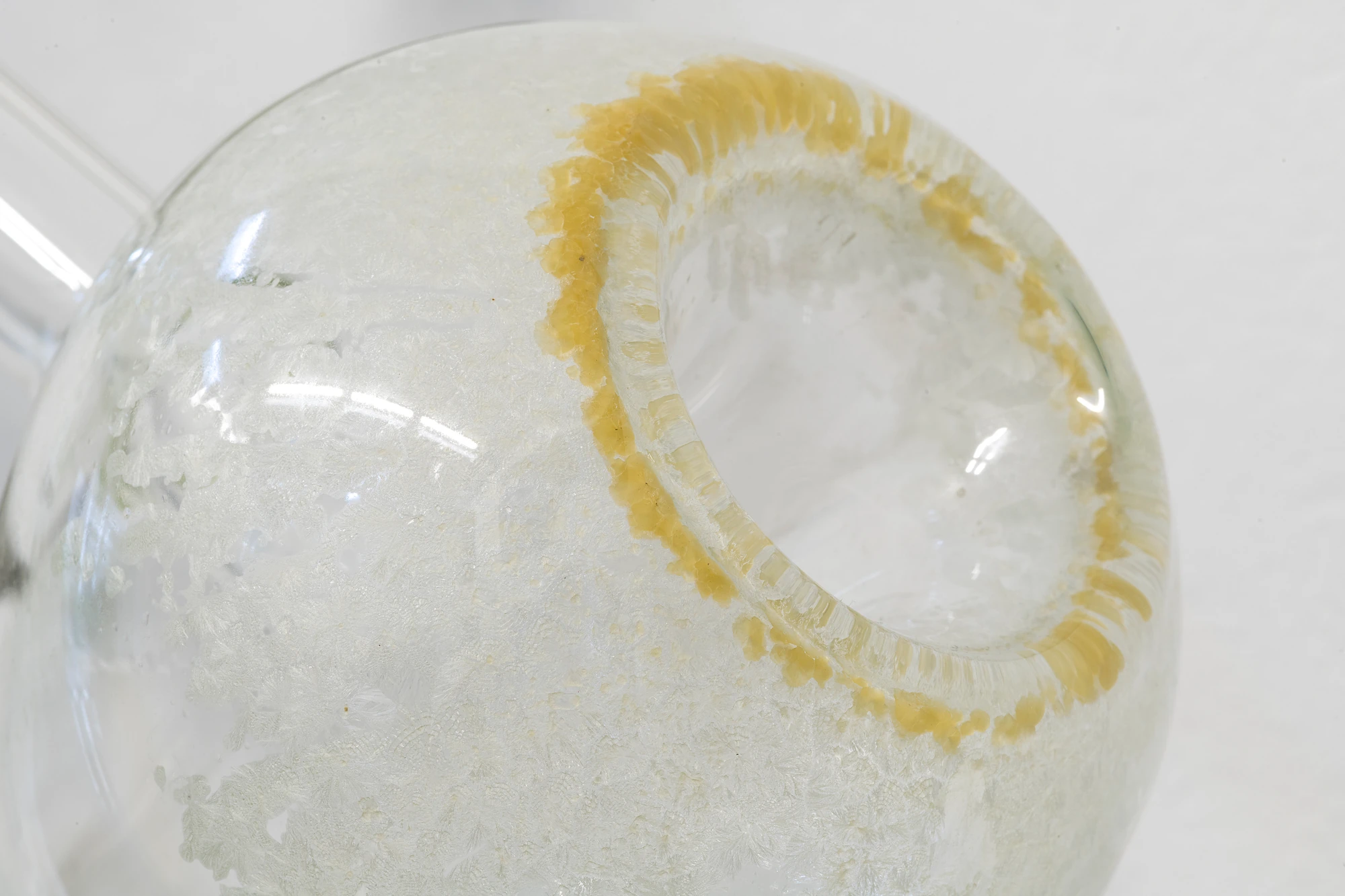 Half-Life of Grace by Jeremy Shaw, photographed by Stefan Korte — A detail of one of the three glass works, a rounded chamber opening where residue has gathered around the rim.