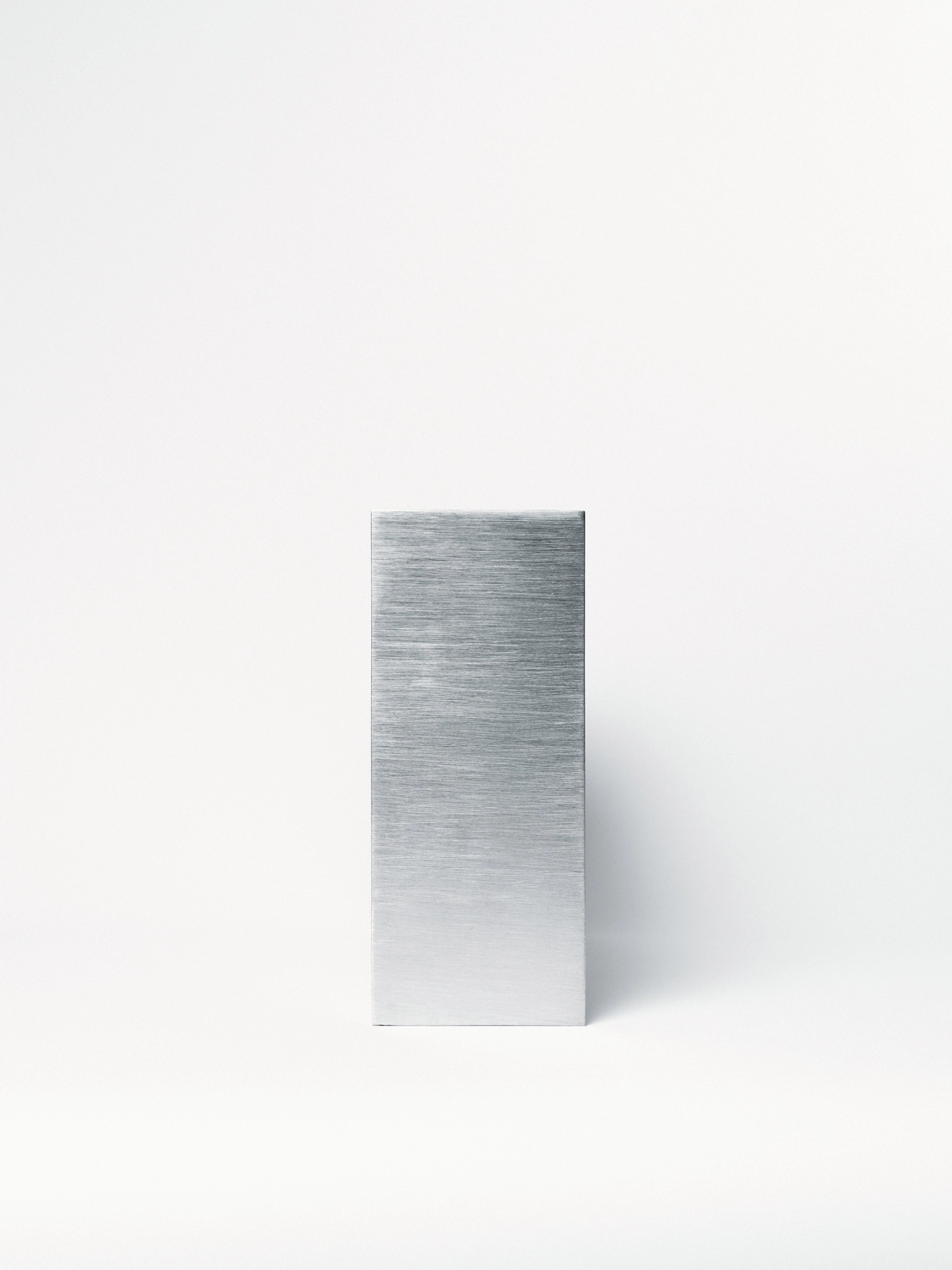 Apropos VASE-21 by Non-Objective, photographed by Elena Gavrilenko — The narrow end of VASE-21 facing the camera, a slim upright plane of brushed stainless steel