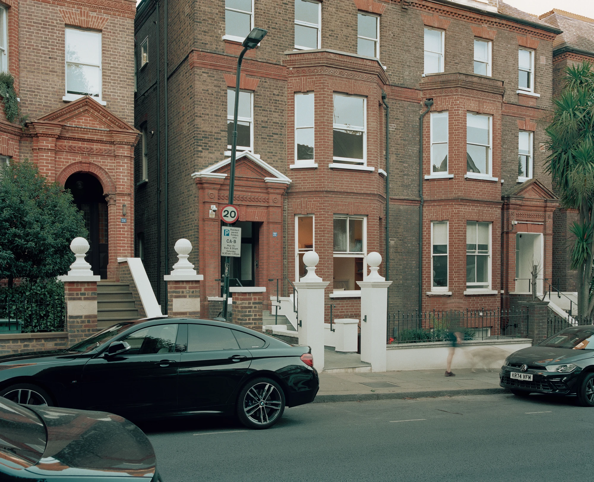Hampstead House by Twelve Forty One, photographed by Willem Pab — The front of the house seen from the street, bay windows and the entrance steps above the pavement.