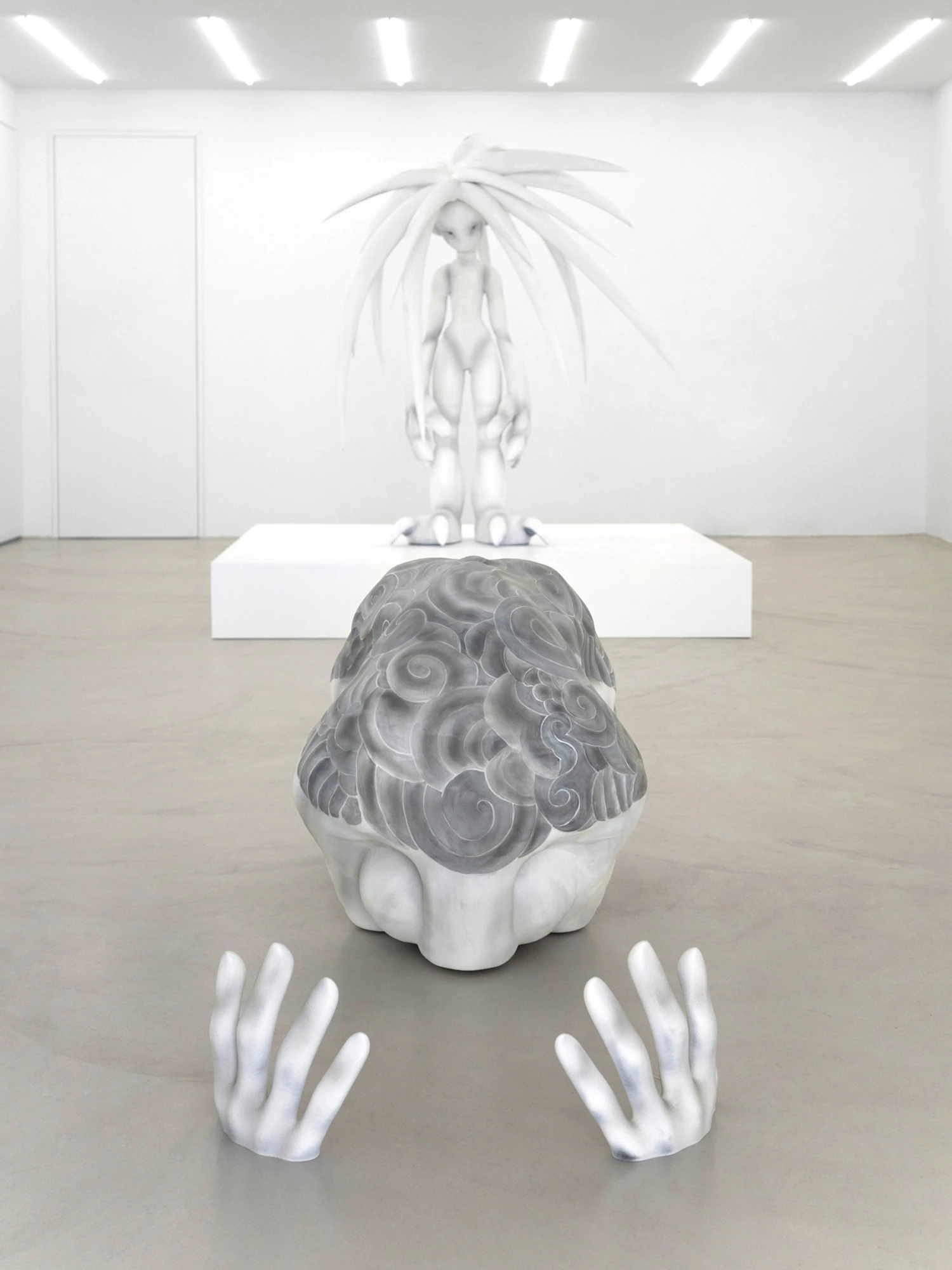 Eureka by Koesy — An installation view of Eureka at MO, the standing figure behind the prostrate one.