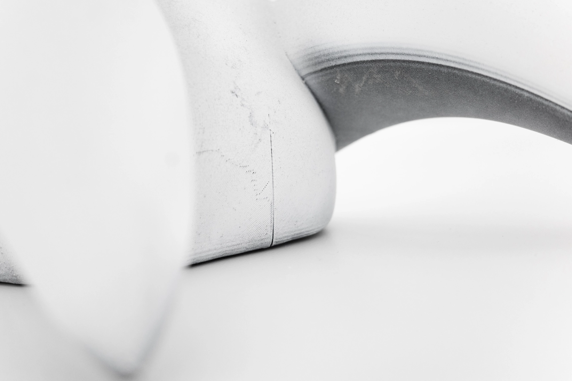 Eureka by Koesy — A close detail of a curved form against a white ground.