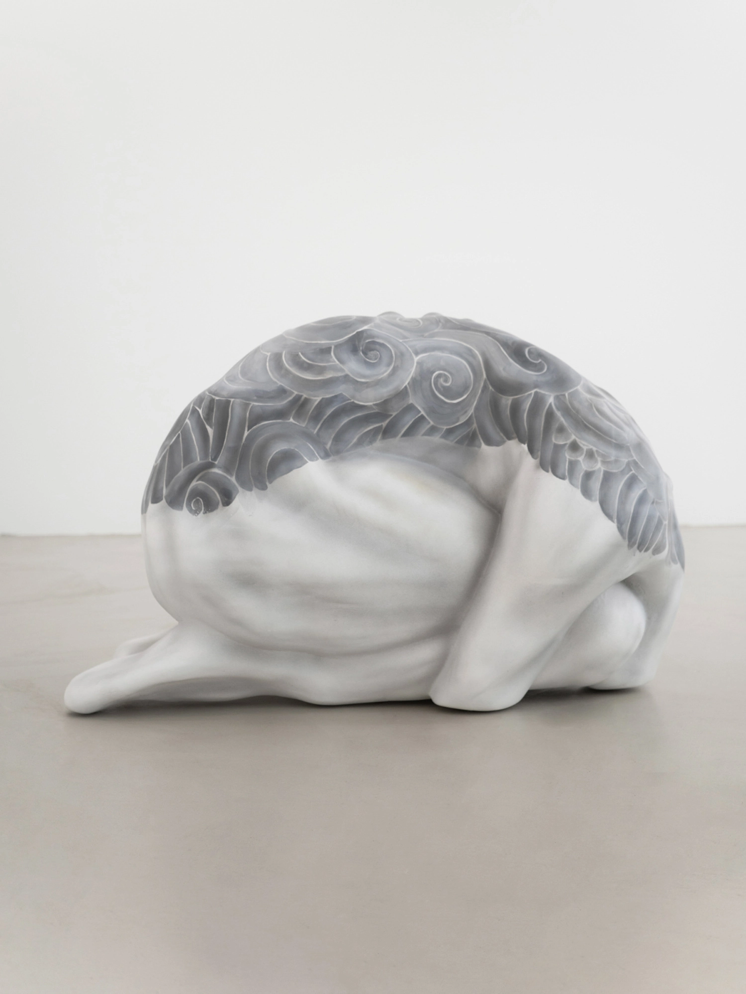 Eureka by Koesy — The prostrate figure, its back covered with tattoo patterns.