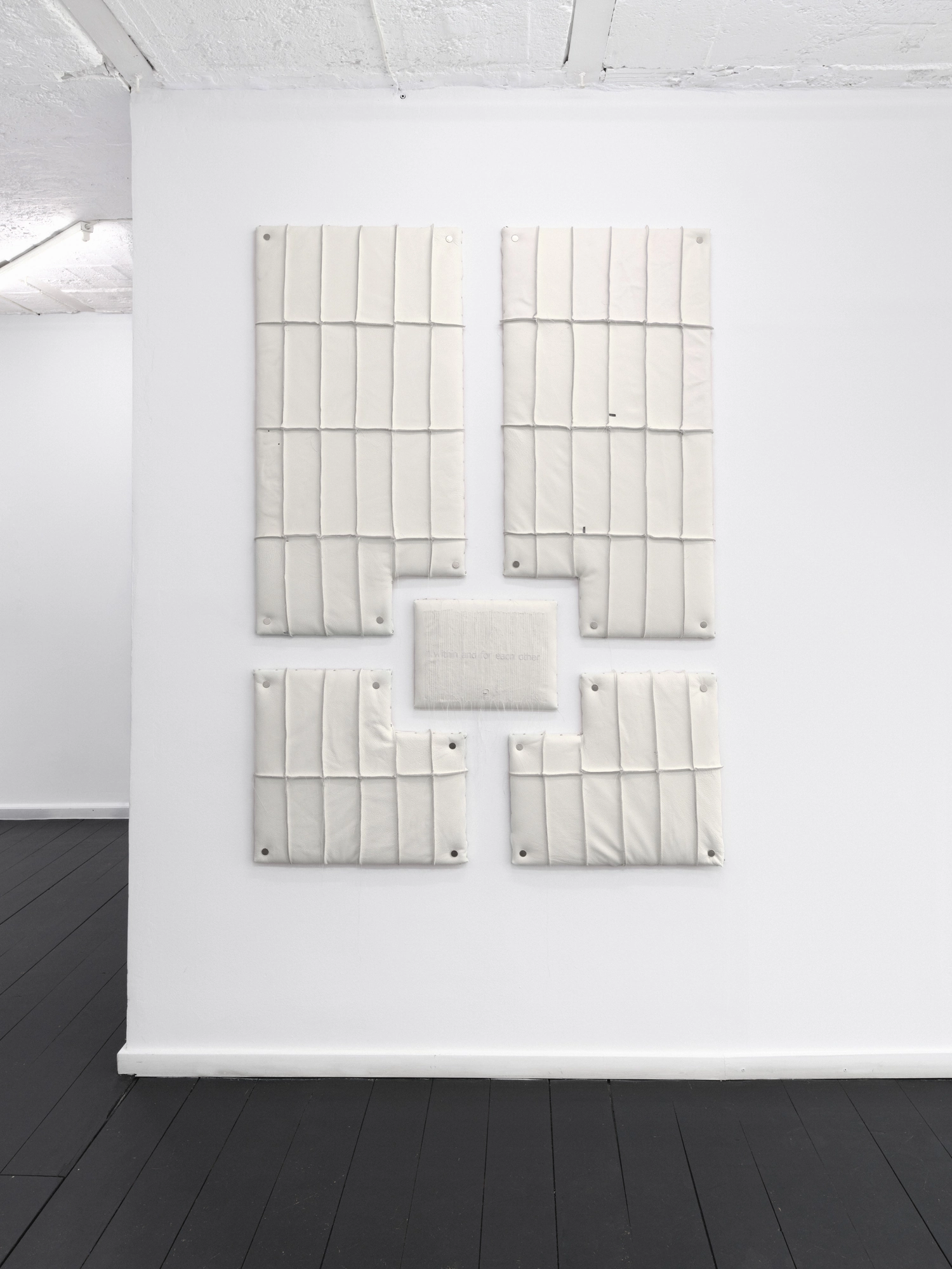 Within and For Each Other by Jan Baszak, photographed by Bartosz Górka — Relief 03 seen front on across the white wall.