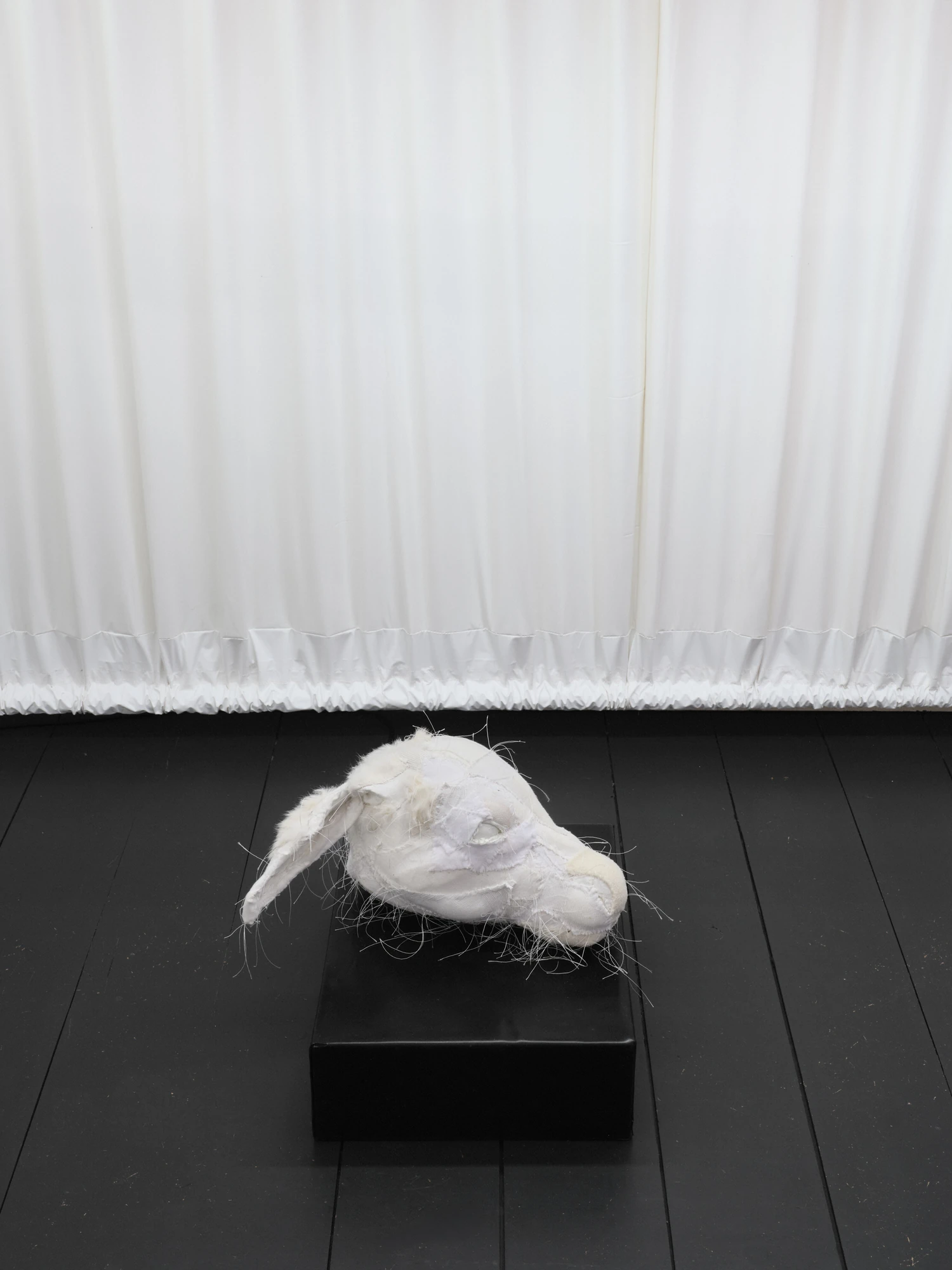 Within and For Each Other by Jan Baszak, photographed by Bartosz Górka — To Flow My Tears set on its plinth before the white curtain.