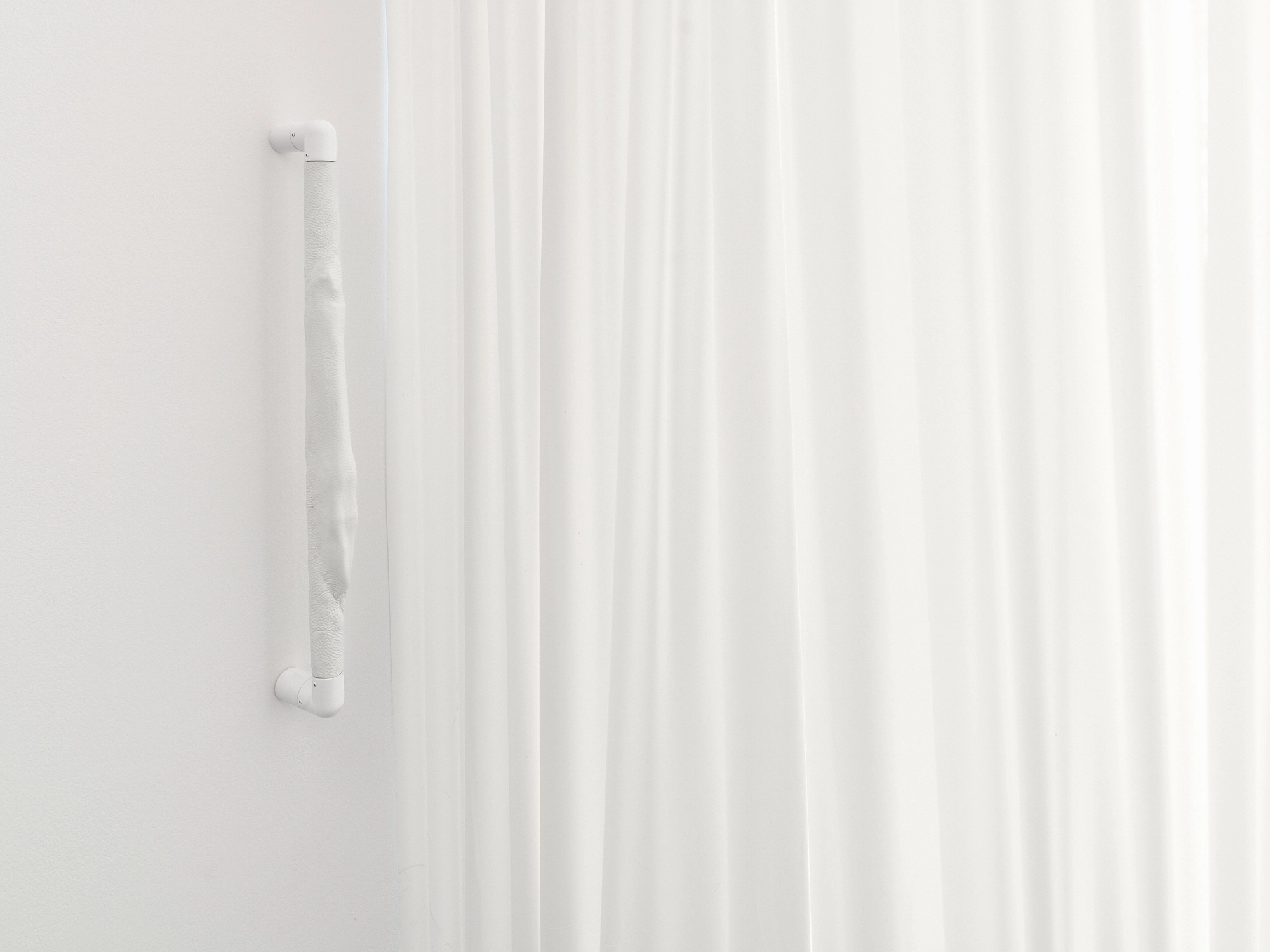 Within and For Each Other by Jan Baszak, photographed by Bartosz Górka — Relief 01 mounted vertically beside the curtain.